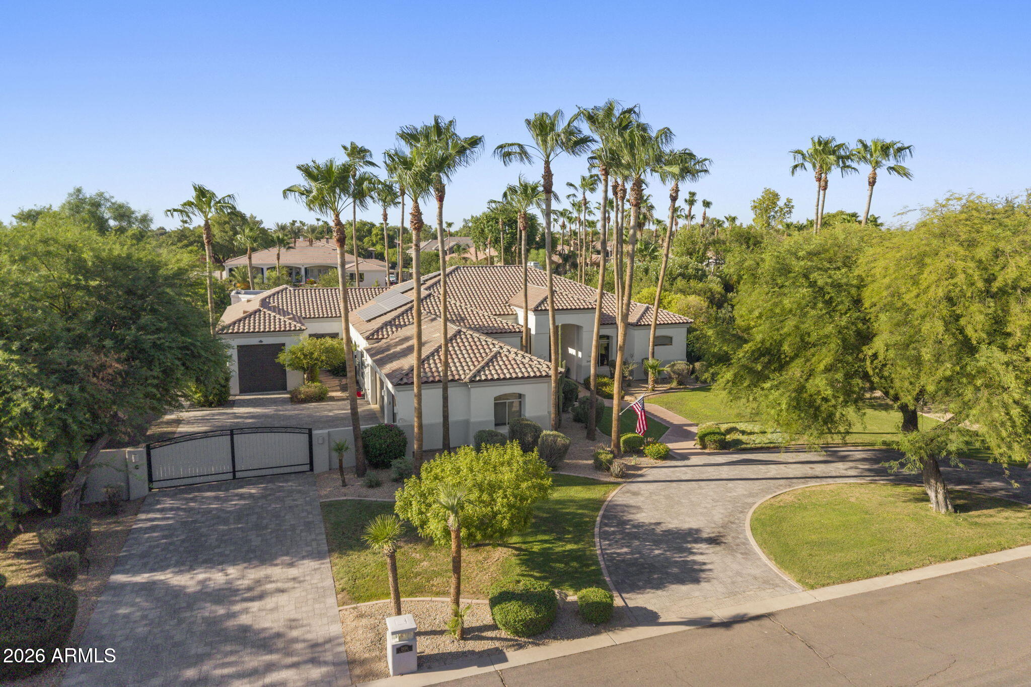 Experience luxury living in the highly sought after Circle G Riggs Ranch in Chandler. This exceptional estate offers over 4,300 square feet with 5 bedrooms and 4.5 bathrooms, including a flexible space with its own private entrance that can serve as a second primary suite, guest quarters, or game room.
With a long list of recent improvements, this home is truly move-in ready. Rich new flooring flows throughout, complemented by stunning wood beams, custom built-ins, and a striking floor-to-ceiling stone fireplace in the living room. The beautifully remodeled kitchen features stainless steel appliances, a large center island, abundant cabinetry, and an open design that fills the home with natural light. It flows seamlessly into the spacious family room, showcasing a ventless fireplace with custom ambient lighting. The primary suite is a private retreat with a spa-inspired bathroom featuring a jetted soaking tub. Additional upgrades include two new air conditioning units, a new roof with an aluminum solar barrier and owned solar panels for outstanding energy efficiency. The home has also been freshly painted inside and out. Step outside to your own resort-style backyard - enjoy a sparkling diving pool, lush mature landscaping, fruit trees, expansive covered patios, cooling misters, and a play area. The grounds are truly one of a kind, featuring two koi ponds stocked with fish, three illuminated waterfalls, and a charming bridge leading to a cozy fire pit with built-in seating--creating the perfect setting for entertaining family and friends.
A private electric gate leads to an expansive parking area and a detached RV garage, offering exceptional space for vehicles, toys, or a workshop.
This is a rare opportunity to own one of Circle G's most extensively updated and thoughtfully designed luxury properties.