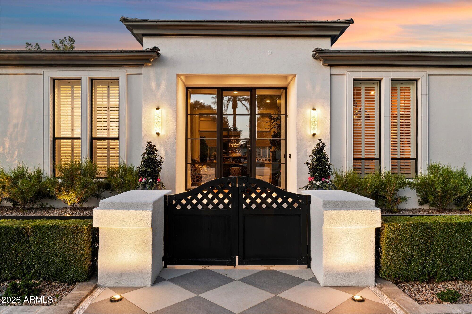 Experience the effortless elegance of Paradise Valley in this exceptional golf course estate. The home was thoughtfully transformed through a professionally designed renovation,. This exclusive residence blends timeless architecture with refined modern luxury. Sun-filled living spaces, soaring ceilings, a chef's kitchen, custom entertaining bar with a custom wine wall create a home designed for both grand entertaining and everyday comfort. 4 bedrooms, 4.5 bathrooms, a private office and versatile den creates the perfect spaces.  The serene primary suite offers a spa-inspired bath and dual custom closets, while beautiful French glass doors open to expansive covered patios, a resort-style pool, outdoor kitchen, and sweeping fairway views. Perfect as a lock-and-leave second home or year-round retreat.  This is Paradise Valley living at its finest!