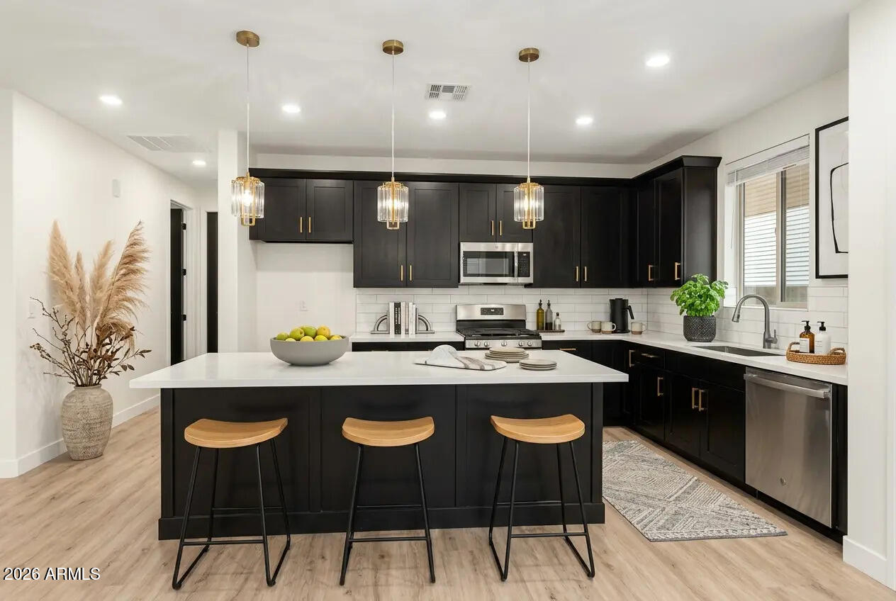 This property checks every box with an oversized lot, open-concept living, and modern upgrades, offering space for animals, toys, and future expansion with move-in ready style. Welcome to this 4-bed home in Tonopah featuring a spacious great room with wood-look flooring and a neutral palette. The kitchen includes quartz counters, subway tile backsplash, stainless steel appliances, pendant lighting, and a prep island with breakfast bar. The primary suite offers dual sinks and a walk-in closet. Enjoy mountain and desert views from the covered patio, plus space for horses, RVs, or future additions, delivering the privacy and flexibility Tonopah buyers are looking for. Some photos include AI-enhanced staging/landscaping for visualization purposes only.