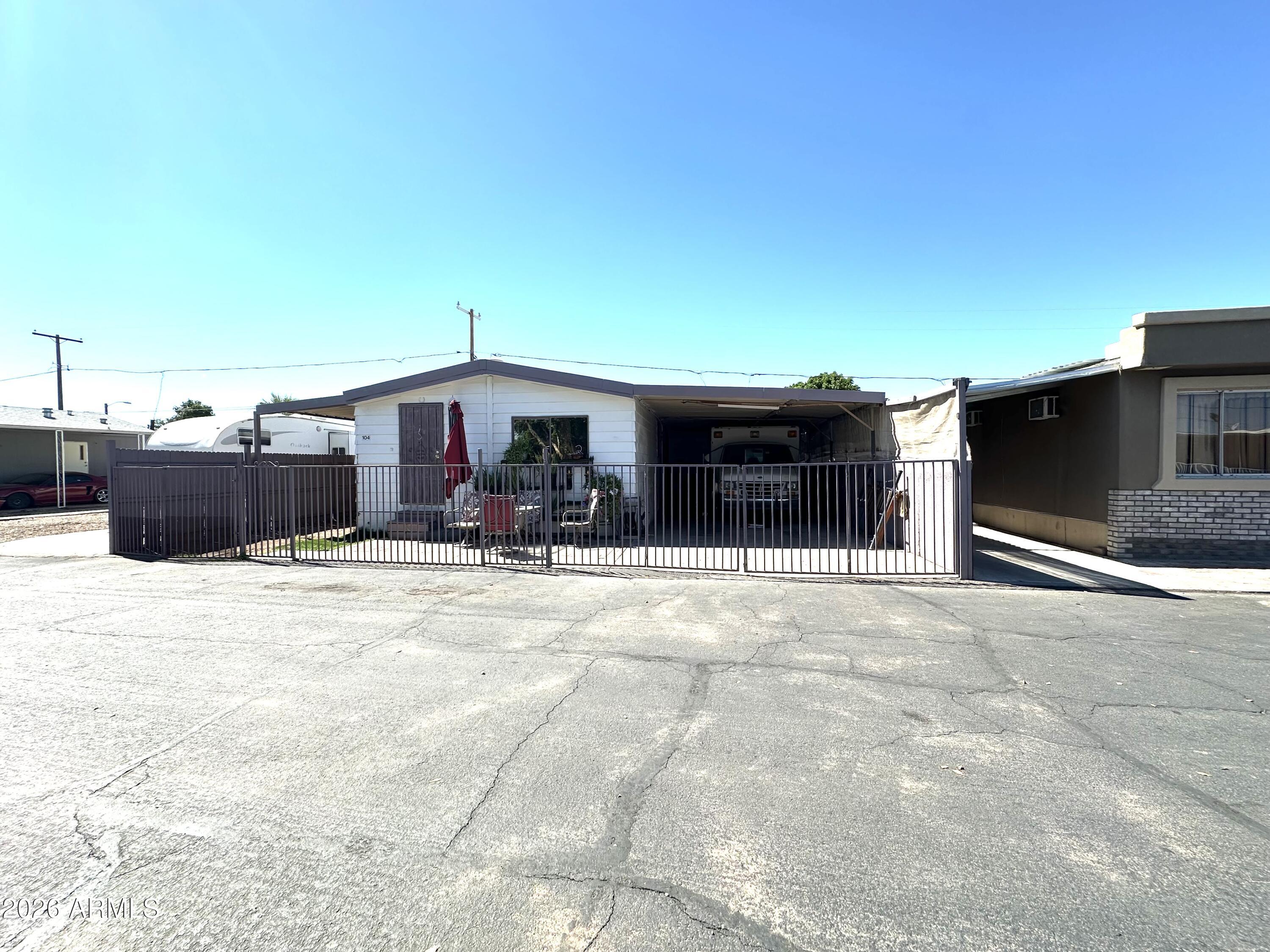 Beautifull Home in the Flamingo Mobile Home Community - a welcoming 4-bedroom, 2-bath residence! Step inside to find a spacious open layout featuring a bright living and dining area with stylish wood-look flooring and a clean, neutral color scheme that suits any décor. The kitchen stands out with abundant cabinet space, sleek granite countertops, a beautiful mosaic tile backsplash, recessed lighting, and stainless-steel appliances ready for your culinary adventures. Each bedroom offers generous closet space, ensuring comfort and convenience for the whole family. Additional highlights include a covered carport and access to the community pool, ideal for relaxing and cooling off during sunny Arizona days. One bedroom separate to Home next to it.