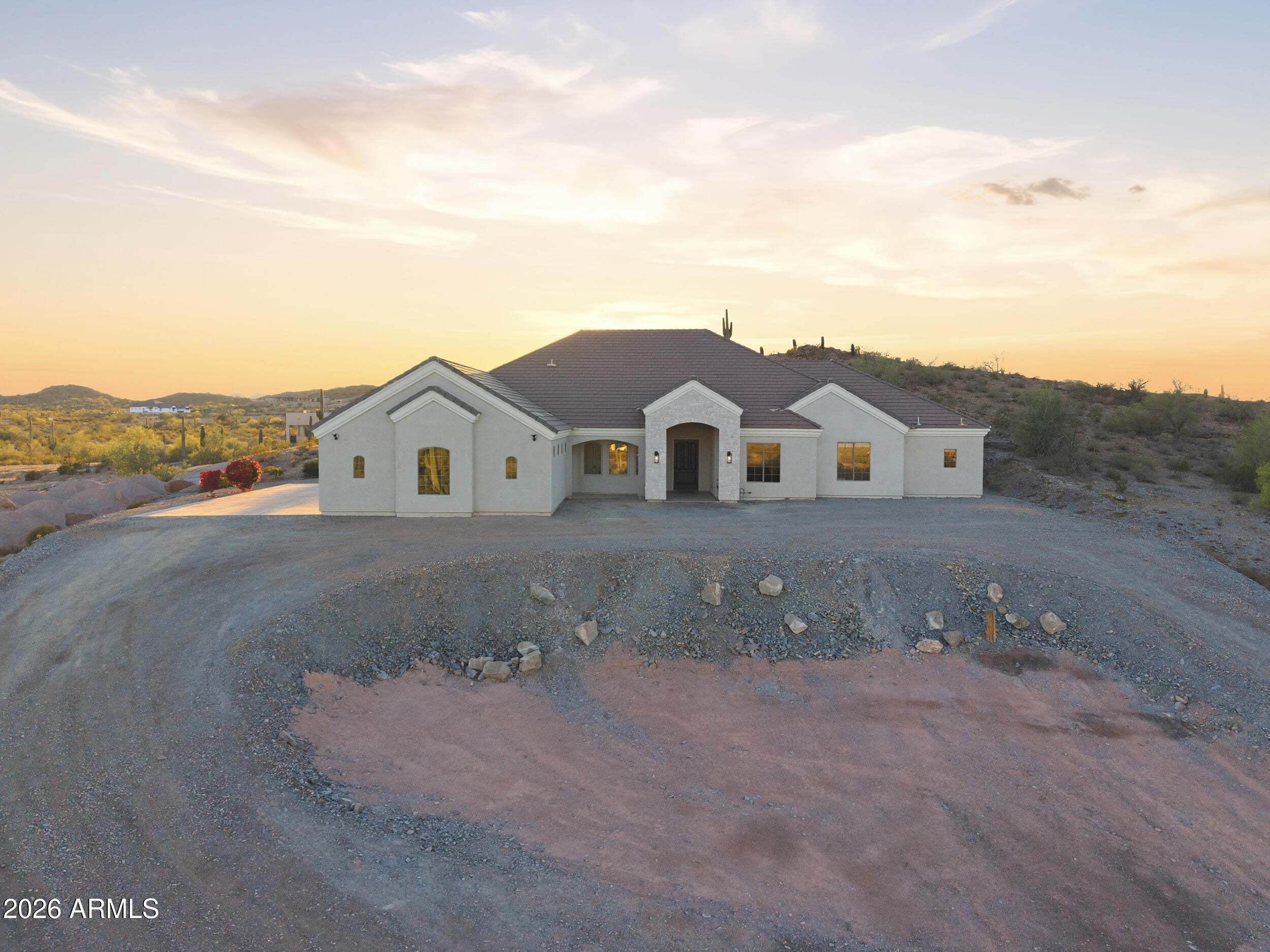Privacy, Serenity, Comfort & Panoramic Mountain & Sunset Views Await You at This 4,000 + Sq Ft Custom Ranch Featuring 5 Bedrooms + Office - 3.5 Bathrooms and 3 Car Garage Located on 1-Acre in Chandler Heights Ranches! Open Concept Living Features 12-Foot Ceilings, Travertine Flooring Throughout, Vaulted Archways, Great Room Perfect for Entertaining, Circular Dining Area + Chef's Kitchen with Island, Walk-In Pantry, Stainless Steel Appliances, Granite Countertops All Open to Great Room Living Area. Upon Entering Find Two Convenient Flex Spaces: Office-Bonus Room and Den-Gym with Closet. Spacious Primary Bed-Bath Suite Offers Spacious Walk-In Closet, Two Separate Vanities with Jetted Soaking Tub Between, Large Walk-In Shower with Bench & Floor to Ceiling Glass Surround! Split Floor Plan Layout Showcases 4 Guest Bedrooms: 2 Bedrooms with Jack and Jill Bathroom, Dual Sinks and Walk-In Shower with Glass Insert - 2 Additional Bedrooms, One with Bonus Room and Direct Access to Back Patio Area, Share Full Bathroom. The Oversized Laundry Room Has Utility Tub, Cabinets, Washer-Dryer Area and Attached Mud Room Room with Direct Access to Back Patio. Retreat to Quiet Backyard Perfect for Relaxing by Brick Fire-Pit. Conveniently Located Near Mountain Hiking and Biking Trails + Entertainment, Shopping, Dining and San Tan Valley Foothills Schools - Yet The Perfect Opportunity To Make This Private, Custom Estate - HOME!