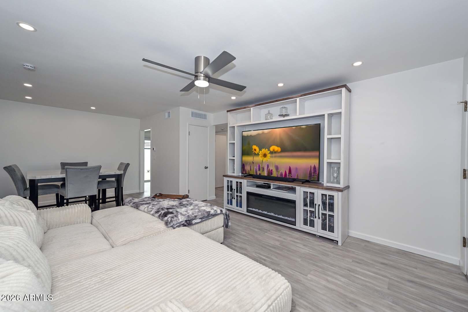 Beautiful renovations costing over $79,000 in 2024.  Dual pane low E windows with blinds, patio sliding door, wood laminate flooring and baseboards throughout, upgraded kitchen with granite countertops, all appliances and refrigerator, cabinets, lights, adding an additional large pantry in kitchen, 40G water heater, remodeled laundry room with washer and dryer and lots of cabinets and all plumbing moved to side walls.  All popcorn ceilings removed and painted inside condo.  Beautiful bathroom with granite countertop, vanity, sink, shower, higher toilet, updated bathroom plumbing. Modern ceiling fans and light fixtures. Trane air conditioner and heat pump, thermostat, and air conditioning added to the laundry room.  Travertine installed in private patio outside and painted patio walls. Outside lights in back and front/back Steel Security screen doors.  Can lights installed throughout. Roof installed 11/2025 and $13,000 in Beautiful furniture purchased in 2024.  THE INSIDE OF THIS HOME IS A MUST SEE!!
Sun City is 55+ and has 8 Rec Centers with fitness gyms, swimming pools, hot tubs, 100's of clubs to join, bowling, outdoor amphitheater, pickleball, shuffle board, pool tables, electronic darts, tennis, mini golf, paddle boats, 8 golf courses, library, dog park and low property taxes.