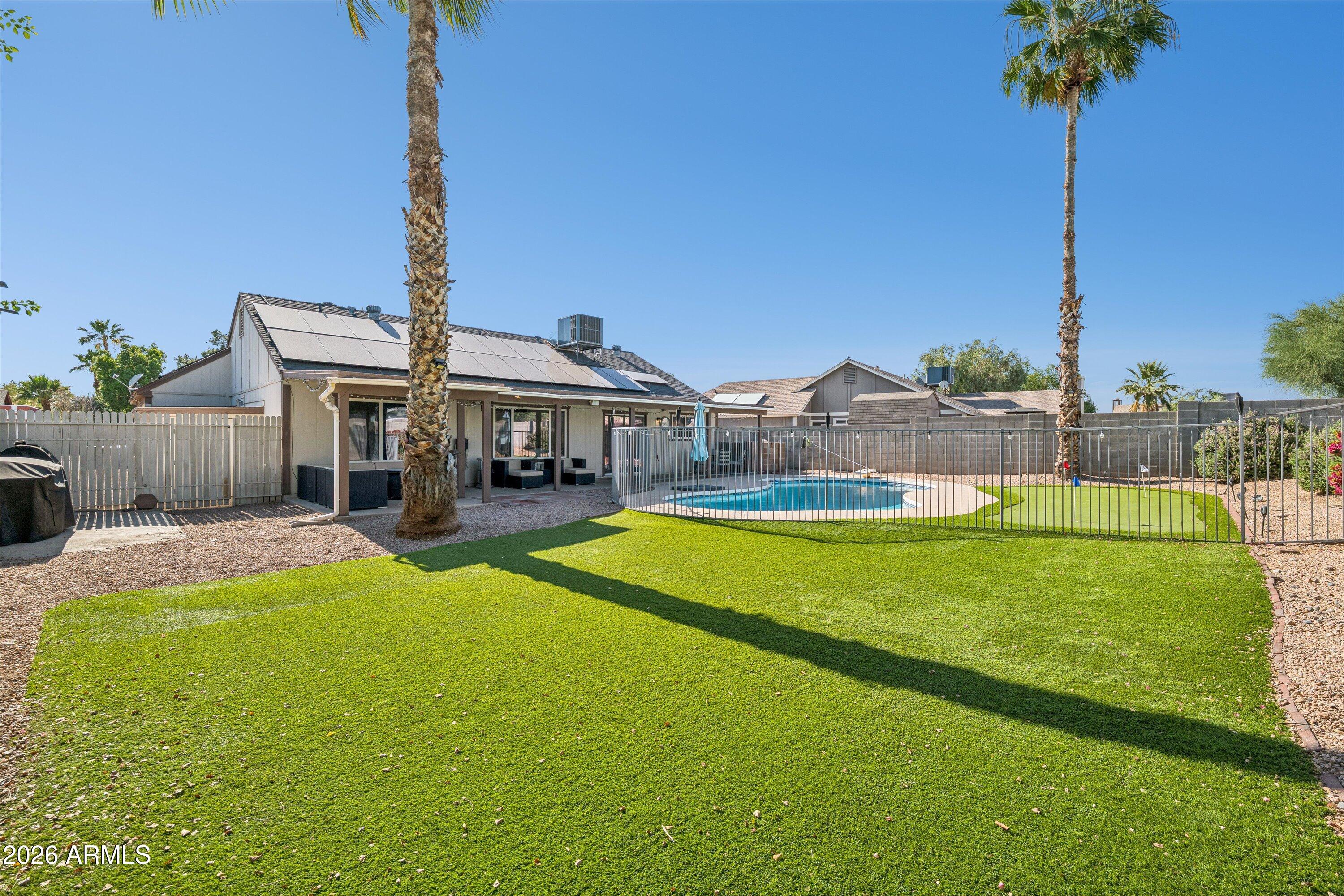 There is more good living in this fabulous GREAT ROOM plan than you would expect! Besides the 4 generously sized bedrooms, and updated bathrooms, there's a built in beverage cooler, unified flooring throughout! Customized kitchen countertops, SS appliances, pantry and a kitchen view to the glorious backyard pool. The bright fresh kitchen has ample counter space to get cooking! Sparkling clean diving pool with fenced play area and excellent putting green! Expanded patio covers the whole back of home. Garage has dedicated electric outlet suitable for car charging. Enjoy entertaining family and friends in this well appointed home on a cul-de-sac lot. Solar panels have an assumable loan at for est. $10 month utility bills.