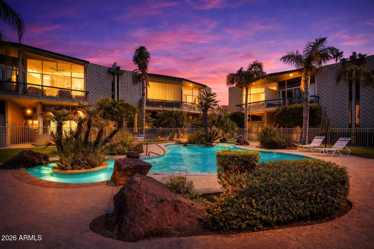 Palm Springs vibes in the heart of Uptown Phoenix. UTILITIES COVERED BY HOA!!! (electricity, water, internet and cable)!!!  Tucked into one of the area's most coveted pockets ''between the 7s,'' this rare mid-century inspired townhome offers the walkable urban lifestyle buyers are constantly searching for; just moments from Postino, Windsor, Churn, Uptown Plaza, The Henry and light rail access.

Inside, this 3-bedroom, 2 full bath residence offers 1,677 square feet of design-forward living with soaring floor-to-ceiling windows, abundant natural light, an open-concept layout, industrial-inspired kitchen and dining spaces, and a highly sought-after main-level primary suite. A striking suspended staircase leads upstairs to two spacious secondary bedroomsm Outside your private patio and a stunning lagoon pool create a true resort-like backdrop rarely found in central Phoenix. The home also includes two covered parking spaces conveniently located just behind the residence.

And in a standout bonus for urban living, the HOA covers ALL utitlities and then some (water, sewer, trash, electric, internet, and cable)

Stylish. Walkable. Design-driven.
A rare Uptown opportunity for buyers who want more than just a home; a lifestyle.
