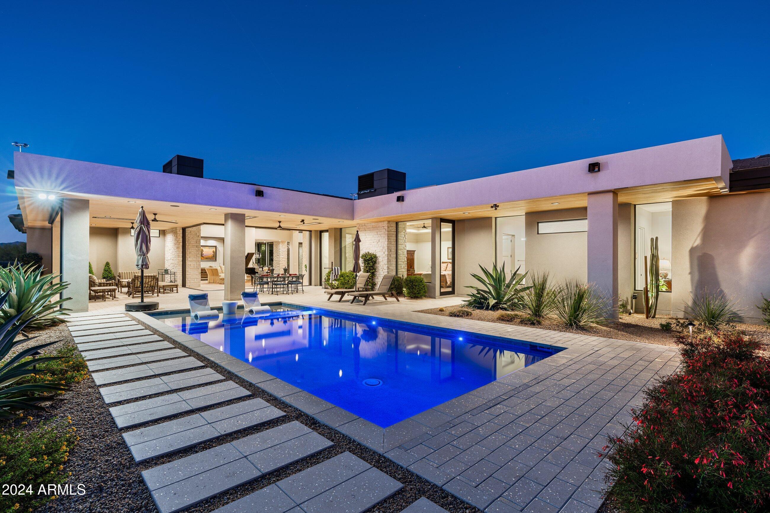 Spectacular contemporary masterpiece built in 2022 by Sonora West Development and designed by Swaback Architects. This home is ''model perfect''and located in the prestigious gated community of Solitude in NE Scottsdale on a quiet N/S cul-de-sac lot.  Breathtaking mountain & sunset views enjoyed from the luxurious backyard retreat with fully retractable 90 degree glass panel doors that merges indoor/outdoor living seamlessly. This home boasts soaring ceilings, an open concept w/clean lines and modern architect, wide plank wood flooring, 
high-end finishes, chandelier and upscale lighting that creates an atmosphere of sophistication and style along  w/functionality. This 4734 square foot home offers 3bdrm/4.5 bath plus office/den and is designed to perfection. The backyard is a true ... oasis featuring thoughtfully designed mature landscaping, a beautiful pool, a cozy fire-pit conversation area, a large expansive patio, built-in BBQ, and multiple seating areas, all ideal for entertaining and relaxing. This exceptional property embodies the best of Arizona living and lifestyle and an entertainer's dream.