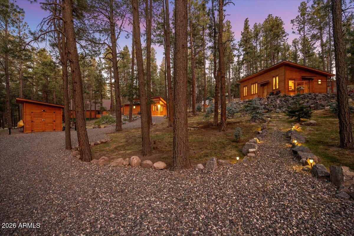 Experience mountain living at its finest in Alpine Estates, where craftsmanship, privacy, and the beauty of Arizona's White Mountains come together on 1.06 heavily wooded acres. This one-of-a-kind property features a custom-built main home completed in 2021 (660 sq ft) and a beautifully appointed detached casita built in 2023 (480 sq ft), offering a combined 1,140 square feet of thoughtfully designed living space.
From the moment you arrive, you'll appreciate the meticulous attention to detail throughout. Custom African hardwood doors welcome you into warm, inviting interiors featuring custom cabinetry, live-edge quartz countertops, spray foam insulation, tankless water heaters, and quality finishes designed for year-round comfort and efficiency.
The detached casita creates endless possibilities for guests, multigenerational living, or a private office, potential while maintaining privacy from the main residence. Both buildings feature their own utilities and septic systems for added
convenience. Outside, the property is truly exceptional. Towering pines, mature Blue Spruce trees, professionally landscaped grounds, winding walking trails, and peaceful outdoor living spaces create a setting that feels like your own private mountain
retreat. Every path invites you to slow down, explore, and enjoy the natural beauty that surrounds you. Additional features include a greenhouse, storage shed, wood stoves, quality appliances, and numerous custom touches that make this property unlike anything else on the market. Whether you're looking for a full-time residence, a weekend escape, or a legacy property to share with family and friends, this Alpine Estates retreat offers a rare opportunity to own a truly special piece of Arizona's White Mountains.