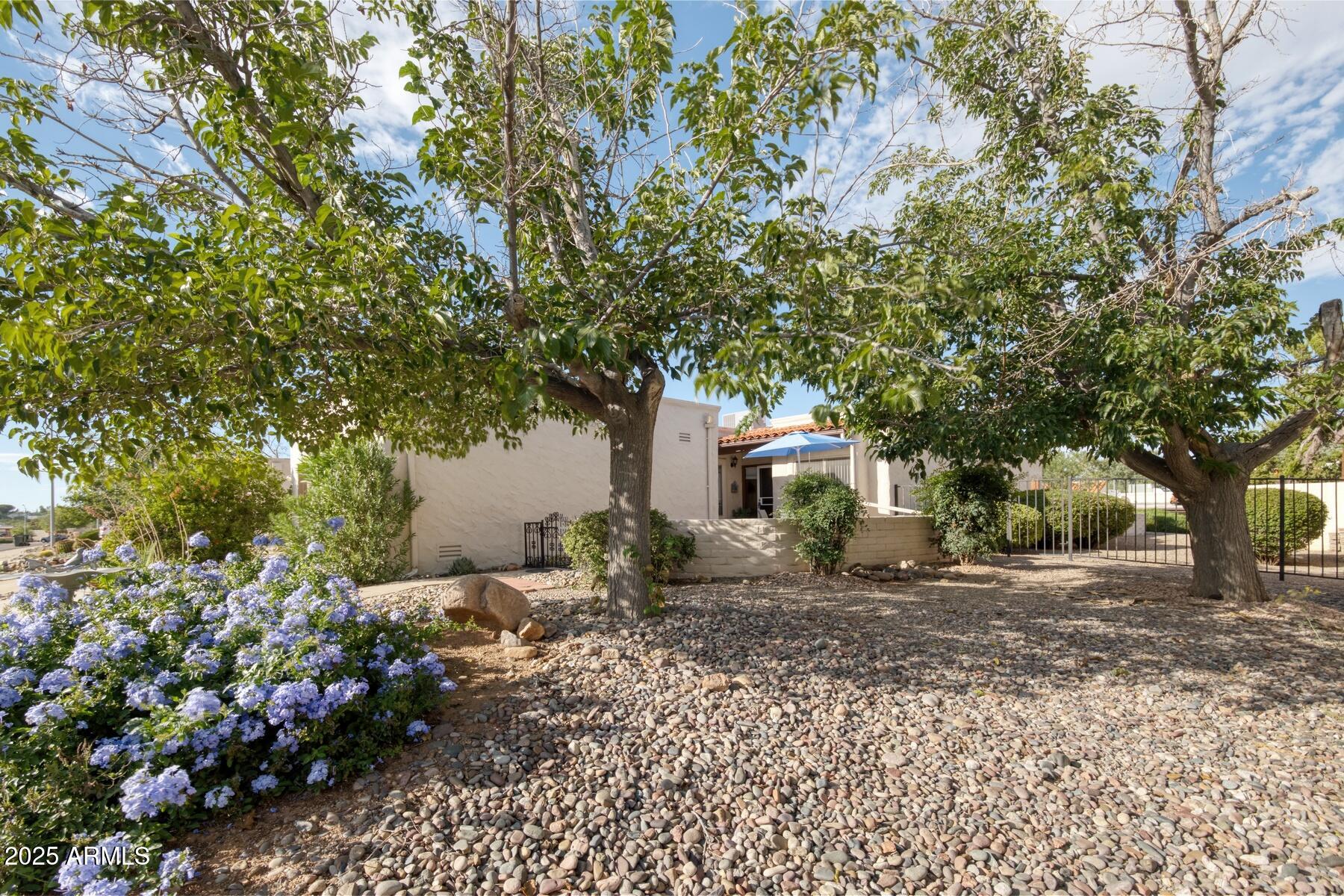 Beautifully maintained 2 bedroom, 2 bath townhouse in a desirable central location. This inviting home features a large living area with a cozy wood-burning fireplace, a friendly kitchen, and rich real wood doors and baseboards that add warmth and charm. Enjoy both front and back patios for relaxing or entertaining. The community offers a sparkling pool, soothing spa, BBQ area, and restrooms—all just a short walk away. Comfort, quality, and convenience in one perfect package!
