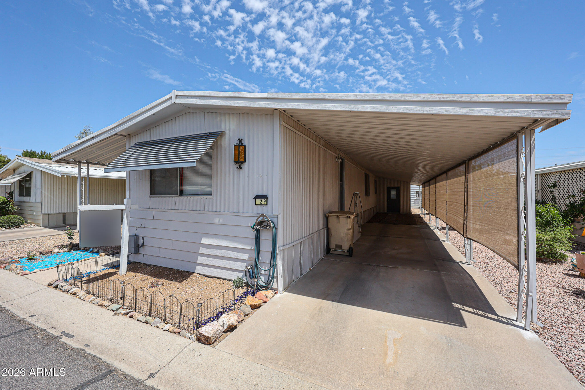 Welcome to the PEACEFUL Casa Del Sol GATED 55+ community with all the safety, comfort and convenience you can imagine. These 2 large MASTER EN SUITES have their own private bed and bath on a SPLIT floor. NEW AC, BATHS, PAINT, ELECTRICAL, INDOOR FULL SIZED LAUNDRY, LARGE DECK and NO CARPET nor NO STAIRS. 
You will love this community of neighbors that have many FULL TIME OWNERS that enjoy the clubhouse socials, fitness center, putting green golfing, billiards and a sparkling swimming pool that is perfect for unwinding in the Arizona sunshine.  
This Community has RV storage and ON-SITE MANAGEMENT which is perfect for LOCK & LEAVE snowbirds or full time occupants.  Near shopping and dining with Westgate Entertainment District and NASCAR nearby. What a quaint community! Community tour below