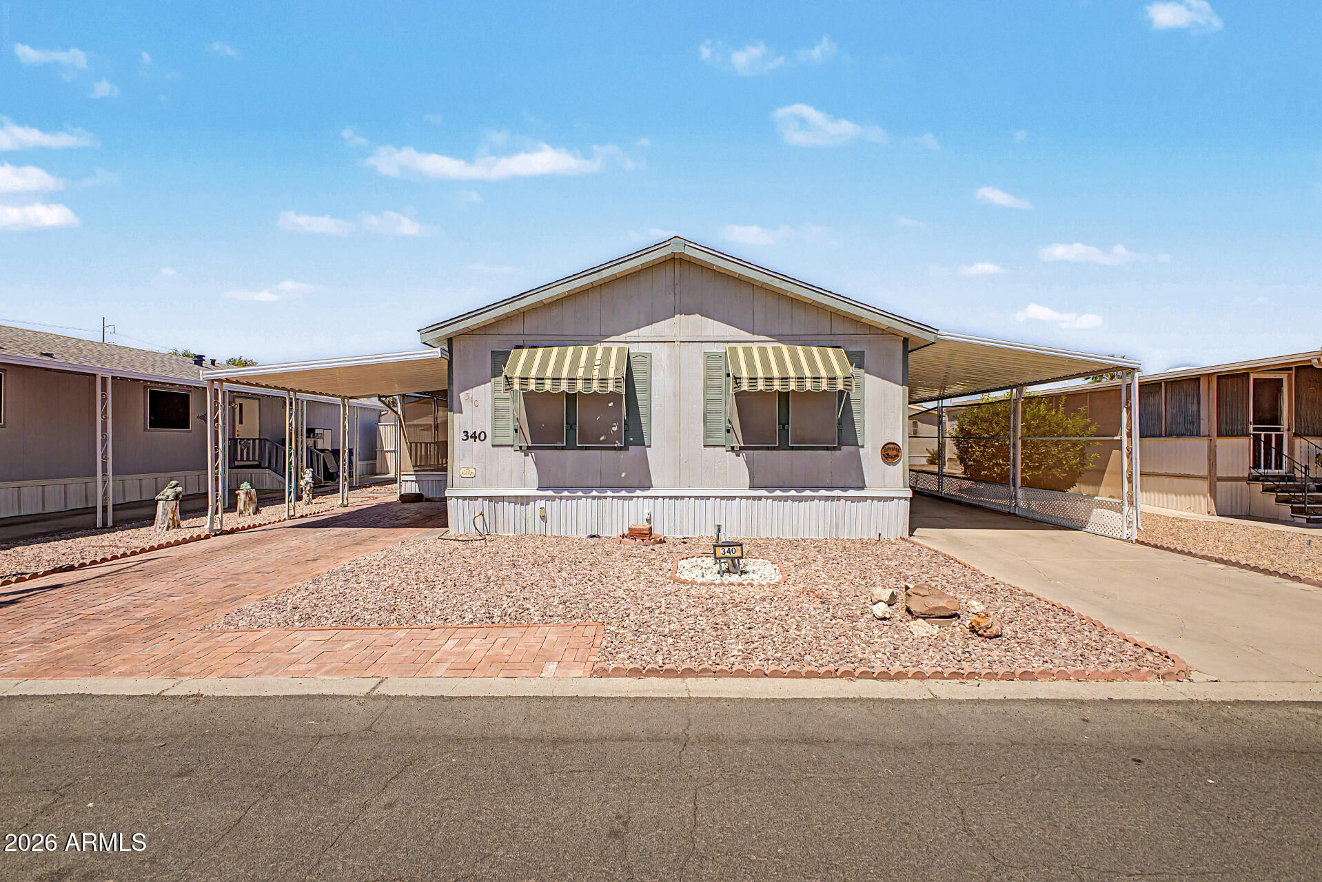 This charming 2-bedroom manufactured home in a gated +55 community is the one for you! You'll be greeted with a cozy covered patio ideal for morning coffee and practical carport parking. Inside, the sizable living spaces flow seamlessly for extra comfort, featuring wood-look flooring, vaulted ceilings promoting an airy feel, plenty of natural light, and neutral paint that pairs well with any decor. The kitchen comes equipped with abundant cabinetry adorned with crown molding, ample counter space, and built-in appliances for a seamless cooking experience. The main bedroom promises a good night's sleep, complete with a practical walk-in closet and a private bathroom. You'll have a workshop perfect for your projects, plus tons of storage space. What are you waiting for?