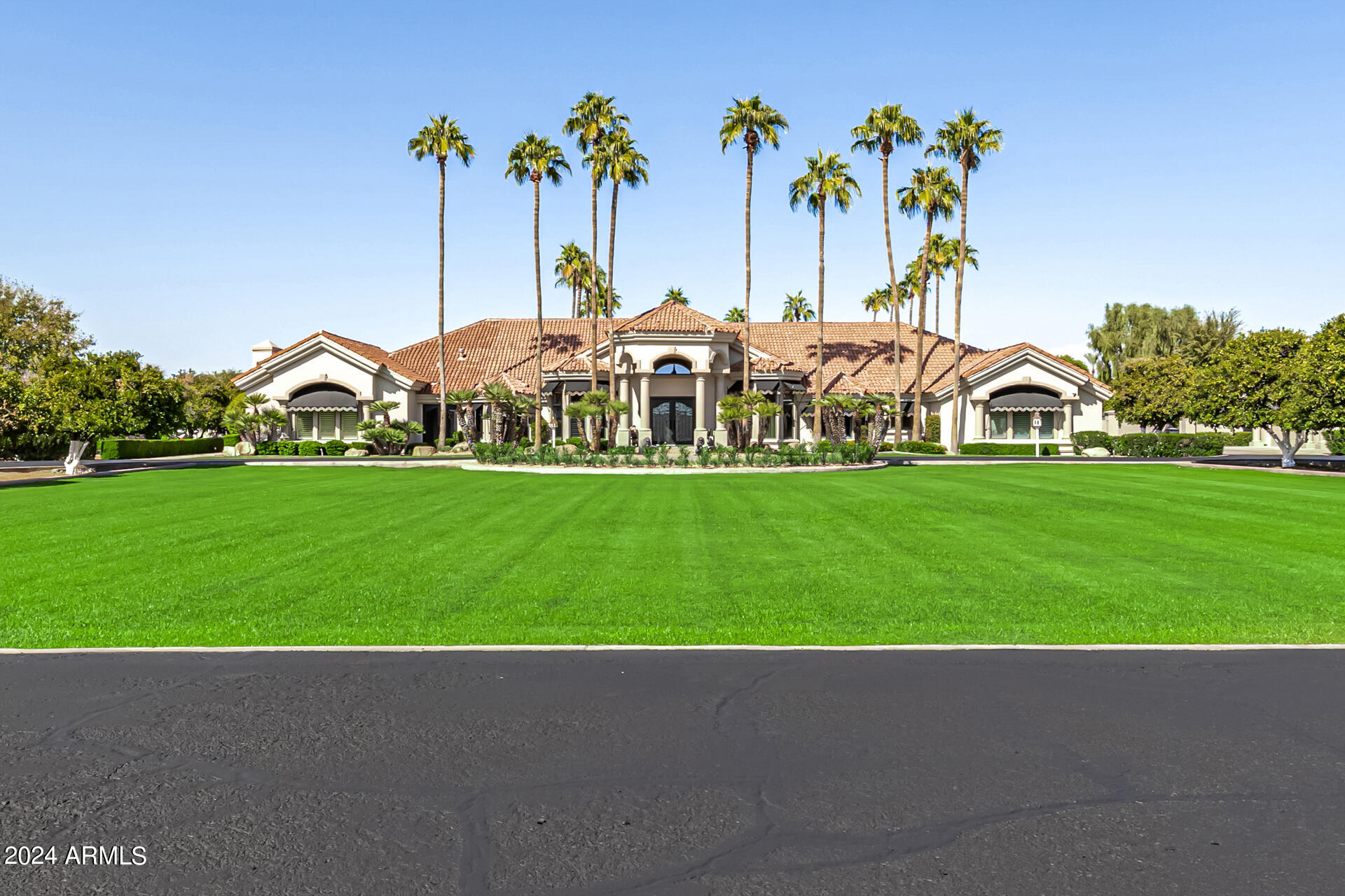 Discover the epitome of luxury living at 3818 East Brown Road, Mesa, AZ. This rare, gated, 4-plus acre equestrian estate is a dream come true for horse enthusiasts and those seeking an unparalleled lifestyle. Nestled in the heart of northeast Mesa, this single-level, custom-built Amberwood home spans 8460 square feet (Main House is 6836sf, guest house is 576sf, guest house basement is 1048sf) and offers an array of exceptional features. The property boasts a 4-stall barn, two tack/feed rooms, a wash rack, and an arena, making it perfect for equestrian activities. Inside, you'll find 4 spacious bedrooms, including 2 primary suites, and 4 well-appointed bathrooms. Primary bathroom has steam shower. The home is designed for both comfort and elegance, featuring formal living, dining, and family room with wet bar, a large office with wet bar, a gym, and a game room with wet bar. Car enthusiasts will appreciate the attached and detached garages that can accommodate up to 10 cars, with 6 garage spaces equipped with A/C. The outdoor amenities are equally impressive, with an amazing custom pool and patio seating, a covered patio with a fireplace, and an outdoor ramada complete with a fireplace and kitchen. The guest house/casita offers additional living space with 1 bedroom, 1 bathroom, a kitchen, and a basement that includes an exercise room and a shooting/archery range. The expansive lot is beautifully landscaped with large front and back lawns, numerous citrus trees, and mature palm trees, creating a serene and picturesque environment. Conveniently located close to the 202 freeway, residents enjoy easy access to all parts of the Phoenix metro area, including PHX Sky Harbor. The property is an ideal choice for families. For recreation, the Mesa Tennis & Pickleball Center at Gene Autry Park are just a short drive away. This home offers the perfect blend of convenience and luxury. This estate is not just a residence but a lifestyle choice for those seeking the best in Mesa living. Don't miss out on this extraordinary opportunity to own a piece of paradise in one of Mesa's most sought-after locations.