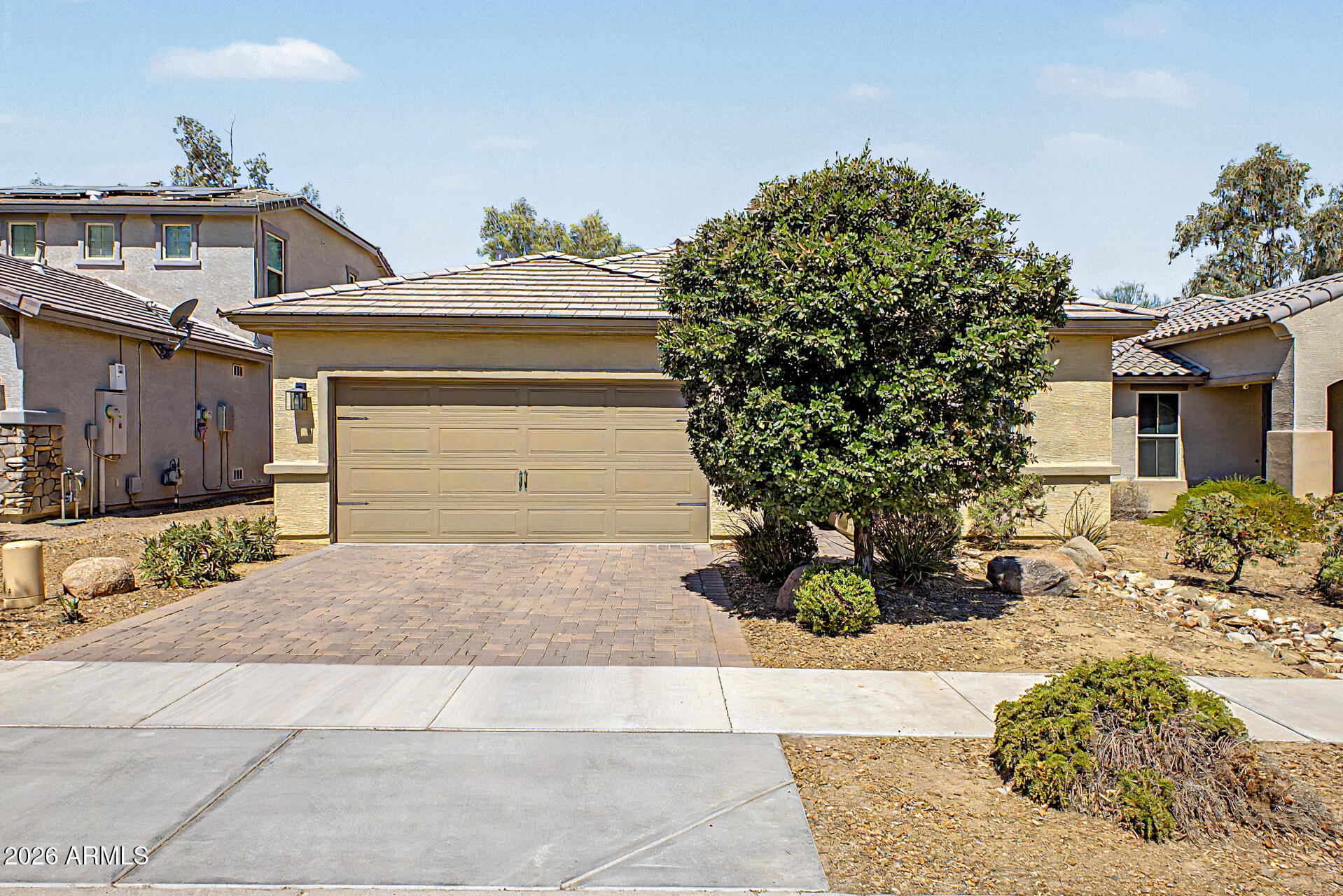 Welcome to an exceptional opportunity in the highly sought-after Grove at Baseline, where modern design, thoughtful upgrades, and an unbeatable South Mountain location come together to create the perfect Arizona lifestyle. Nestled at the base of the breathtaking South Mountain Park and Preserve, this nearly new 3-bedroom, 3-bathroom residence offers the ideal blend of comfort, style, and convenience.

From the moment you arrive, you'll be captivated by the home's stunning curb appeal, featuring mature landscaping, a paver driveway, and an inviting architectural design. Inside, an open-concept floor plan showcases beautiful tile flooring, designer lighting, and a warm, sophisticated great room anchored by a stylish recessed fireplace. Designed for both everyday living and effortless entertaining, the home features a spectacular newly renovated custom bar complete with a sink, wine refrigerator, and ice maker--creating the ultimate gathering space for family and friends. The gourmet kitchen is equally impressive, offering rich staggered cabinetry, granite countertops, a designer tile backsplash, stainless steel appliances, and a large island perfect for casual dining and entertaining.

The spacious primary suite serves as a private retreat, featuring a luxurious ensuite bath and generous walk-in closet. Two additional bedrooms and bathrooms provide comfortable accommodations for family, guests, or a home office setup.

Step outside to your beautifully designed backyard oasis, where a covered patio and attached pergola create the perfect setting for morning coffee, weekend barbecues, or relaxing Arizona evenings under the stars.

Ideally located near top-rated schools, Raven Golf Club, shopping, dining, hiking trails, and the vibrant South Mountain area, this move-in-ready home offers the rare opportunity to enjoy a nearly new residence with premium upgrades already completed. Homes of this caliber in this location are rarely available--don't miss your chance to experience one of South Phoenix's most desirable communities.