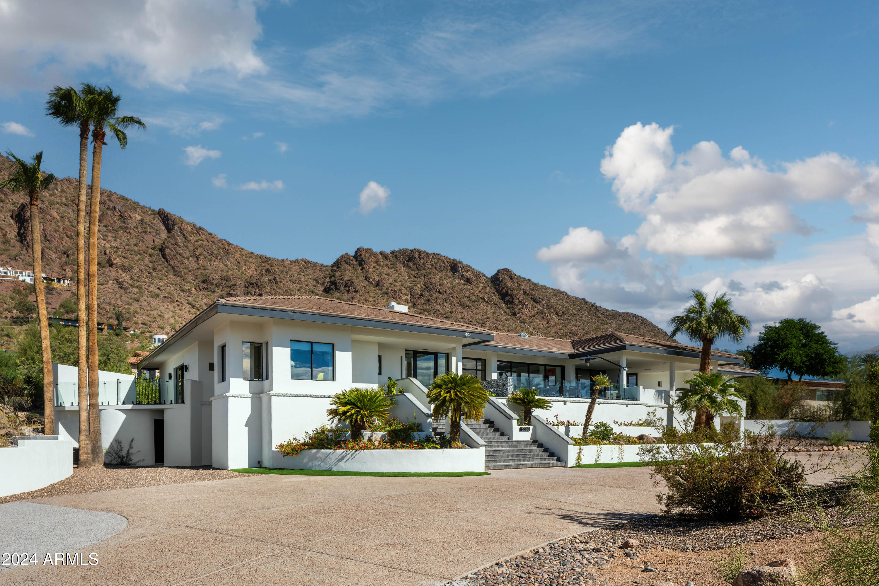 Nestled on the prestigious slopes of Camelback Mountain, this newly remodeled architectural masterpiece by renowned Phoenix architect George Christensen offers the perfect blend of modern luxury and natural beauty. With breathtaking panoramic views of both the glittering city skyline and the iconic Camelback Mountain, this home provides an unparalleled living experience in one of Arizona's most sought-after locations.

Every inch of this meticulously designed home has been carefully curated to offer the utmost in comfort, style, and functionality. Expansive floor-to-ceiling windows bathe the interiors in natural light, framing the spectacular views from nearly every room. The open-concept living spaces feature sleek, contemporary finishes, soaring ceilings, and high-end materials that seamlessly merge with the surrounding desert landscape.

The gourmet kitchen is a chef's dream, equipped with top-of-the-line appliances, custom cabinetry, and an oversized island perfect for entertaining. The spacious living and dining areas open to a stunning outdoor terrace, offering a serene oasis in the heart of the city.

The master suite is a private sanctuary with sweeping views, a luxurious en-suite bath, and a spacious walk-in closet. Additional bedrooms and a separate flex office with its own roll up door provide ample space for work, family and visitors, each offering its own views of the desert landscape.

Designed to embrace the beauty of its surroundings, this home incorporates sustainable, energy-efficient features while maintaining a timeless aesthetic. The lush desert landscape and expertly crafted outdoor spaces provide the ideal backdrop for both intimate gatherings and large-scale entertaining.

Whether you're seeking tranquility, adventure, or simply a place to enjoy the best of Phoenix living, this exceptional home on Camelback Mountain offers it all. Don't miss your chance to own a piece of architectural history in one of Arizona's most prestigious locations.