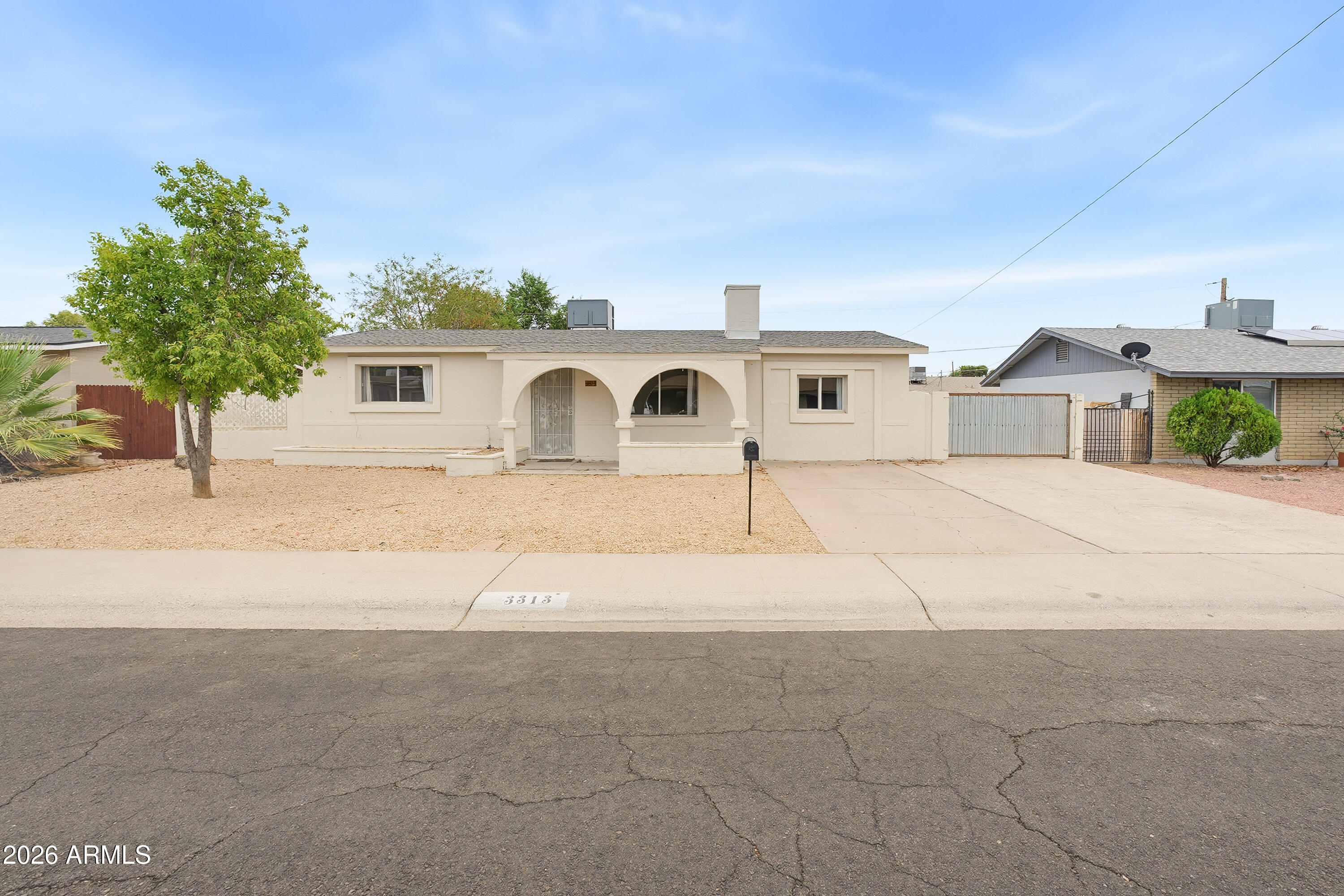 Come see this beautifully updated 3-bedroom home with great location! Upon arrival, discover a low-maintenance front yard and plenty of parking space. Inside, you'll find a sizable living room with an inviting fireplace and a custom mirrored accent wall. The kitchen is equipped with white cabinetry, sleek quartz countertops, stainless steel appliances, and a charming dining nook with a built-in bench nestled in an angled bay window. Soft, warm paint, recessed lighting, and tile flooring throughout. Each bedroom offers ceiling fans and closets for optimal comfort. The spacious backyard boasts a full-length covered patio perfect for entertaining or unwinding in peace. Enjoy the close proximity to schools, restaurants, markets, and easy access to the I-17. What's not to like?