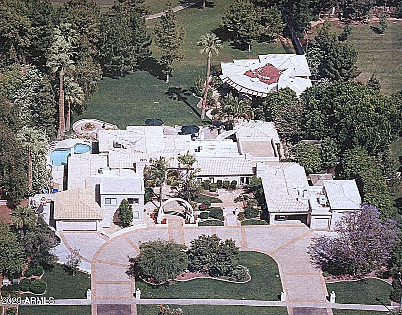 Best of Biltmore! This 1933 ESTATE home, rich with Prestige & History, was built by the Arizona Biltmore Hotel by the Wrigley family for their personal use. The scale of this property is suited for grand entertaining. 6 oversized garages,TWO real guest quarters, plus the main residence. The larger guest home is over 2000 sq. ft.,with 4 fireplaces, roof deck, designed by world famous architect, Jeffrey Page w/SpaceLineDesign Creative Architectswas featured in numerous publications.The other guest home is two story w/own fireplace & kitchen. The main residence is directly on the Biltmore Links Golf course, has 175 foot frontage, overlooking the golf course lakes & Camelback Mountain &Praying Monk. Main residence has 3 fireplaces,6 bedrooms which includes maid's room &service kitchen area. E residence sourrounded on all sides w/ many specimen plants, lush and exotic, and a bougainvillea nearly 100 years old. This is a great property for someone who understands grand understated elegant living. Seller will take a property in exchange.