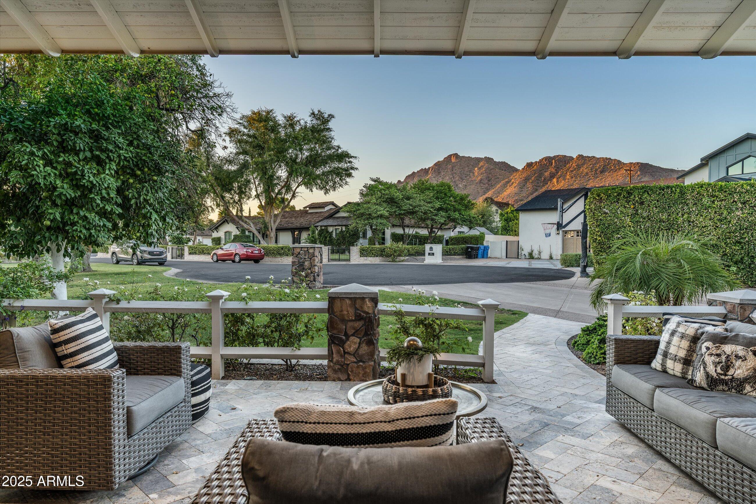 Tucked away on one of the most private cul-de-sacs in Arcadia Proper sits this beautifully renovated & well appropriated half acre property with sweeping Camelback views that put it in a class of it's own. 
You'll be greeted by the most inviting front courtyard terrace & once inside, you'll find a functional floor plan where there's a seamless blend of bright indoor outdoor living. Recently refreshed by Bent Nails, this incredible home offers 4 en-suite bedrooms, all with custom designer bathrooms & walk-in closets, plus a game room & an office. Top it off with a beautiful detached private one bedroom Casita with its own designer bathroom. 
Upstairs, the perfectly calm & spacious primary suite offers your very own private Camelback views. The primary bath features custom dual vanities, a tiled walk-in shower, a soaking tub, custom lighting and his & hers closets. The gorgeous dining room with custom wood molding, new lighting & oak wood floors features French doors that open up to the capture Camelback views from the front terrace. The newly updated gourmet kitchen features custom cabinetry, double islands, newer SubZero fridge, two sinks, stainless ice maker, double dishwashers & gas dual oven Wolf range, refreshed fixtures & LED lighting. More gorgeous French doors wrap around the beautiful bright family room and offer easy access to the grassy backyard. 
Desert nights are best spent in the newly refreshed backyard with lush mature trees. Cook in the fully equipped outdoor kitchen with built-in BBQ grill, dine al fresco under the trees or take a dip in the newly updated heated pool & spa. The batting cage with pro pitching machine will make you the most popular house on the cul-de-sac. 
Rare air conditioned 4 car garage with an incredible amount of storage plus an oversized laundry room with custom cabinetry, a stainless LG washer/dryer, utility sink & an abundance of storage make this property truly one of a kind!