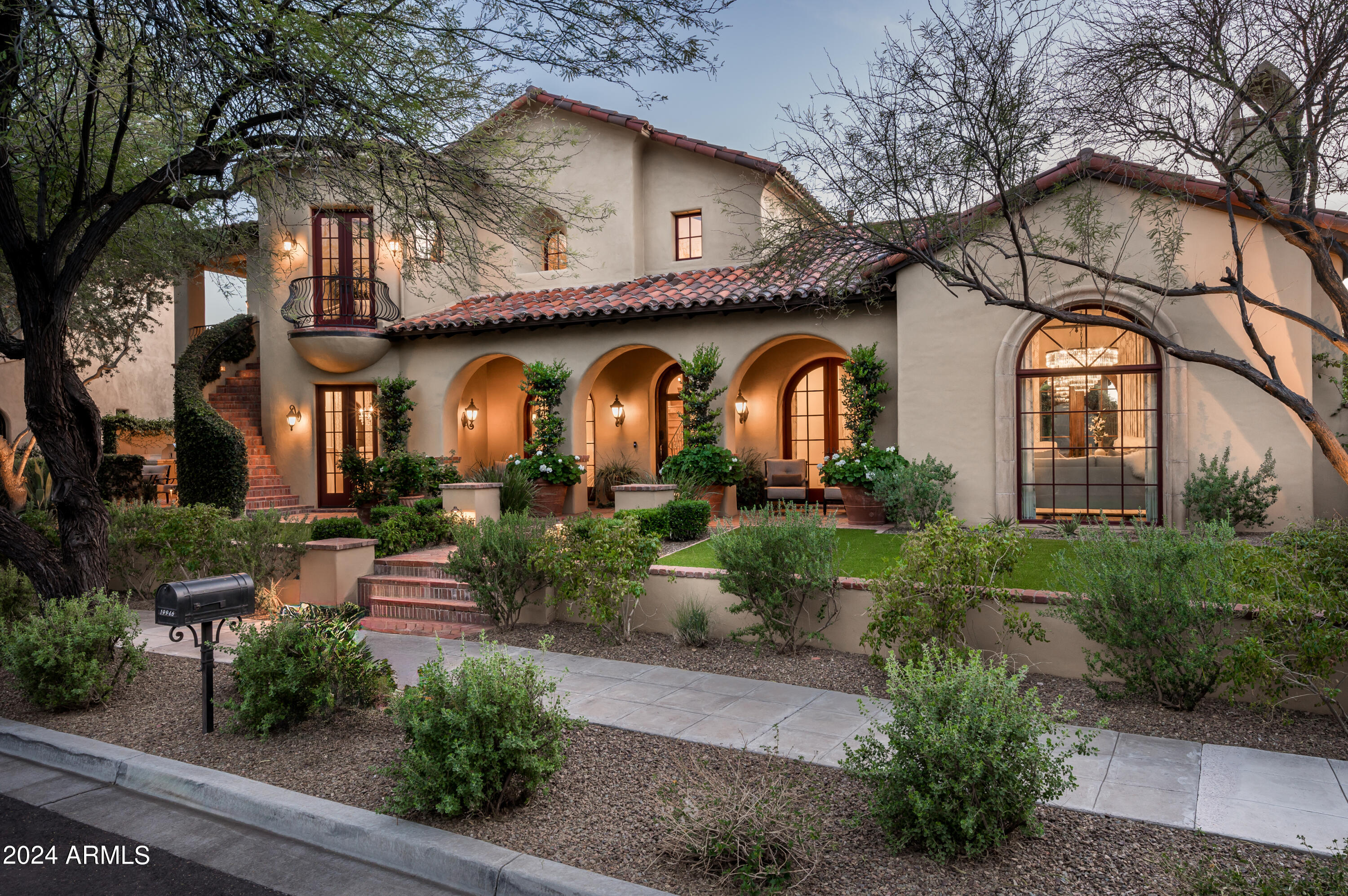 SILVERLEAF CLUB GOLF MEMBERSHIP AVAILABLE! Nestled next to the tranquil waters of the private lake at Desert Springs Park, this home in Silverleaf embodies the timeless allure of Spanish Colonial architecture, offering a perfect blend of elegance, comfort, and charm for discerning homeowners seeking a sanctuary in the heart of Scottsdale's most exclusive community. As you approach from the private, tree lined street, your first glimpse of the home is nothing short of captivating, exuding curb appeal with its stately presence and lush, meticulously manicured landscaping. Step inside and you are delighted by interior spaces that are designed to be both welcoming and intimate, with cozy alcoves for quiet moments and larger gathering areas perfect for entertaining.