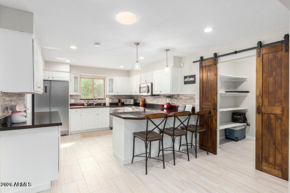 **Resort-Style Living in the Heart of Old Litchfield Park - No HOA!**
Welcome to the highly sought-after Wigwam community, where timeless charm meets luxury lifestyle. Located in the heart of Old Litchfield Park, this beautifully updated 4-bedroom, 2.5-bath home offers the rare opportunity to live in one of the West Valley's most desired golf course communities--without the restrictions of an HOA.
Enjoy access to the world-renowned Wigwam Resort, featuring **three championship golf courses **resort-style amenities, dining, and exclusive golf packages. This is true golf cart community living, where you can cruise to dinner, the course, or local events with ease. Inside, the home offers spacious living with soaring vaulted ceilings, skylights, and an open, inviting layout. Designer touches include staggered large-format ceramic tile, updated fixtures, and abundant natural light throughout. The kitchen is built for both function and entertaining, featuring granite countertops, a wet bar, and a large walk-in pantry with custom barn doors.
The family room is warm and inviting with a two-way gas fireplace, perfect for cozy evenings or entertaining guests. The expansive primary suite offers a true retreat, complete with two large walk-in closets and a private exit to the backyard.
Step outside to your private oasis--designed for Arizona living. Enjoy a heated pool and in-ground spa, large covered patio, and low-maintenance artificial turf, all supported by a commercial-grade irrigation system.
Additional features include an indoor laundry room with storage, updated windows and doors, and a functional layout ideal for both everyday living and entertaining.
Beyond the home, you'll love the lifestyle this community provides--tree-lined streets, walking and biking paths, top-rated schools, and nearby dining and shopping, with even more growth and development coming to the area, including the exciting Litchfield Park Square.
Opportunities like this in Old Litchfield Park are rare--resort-style living, golf community access, and no HOA.