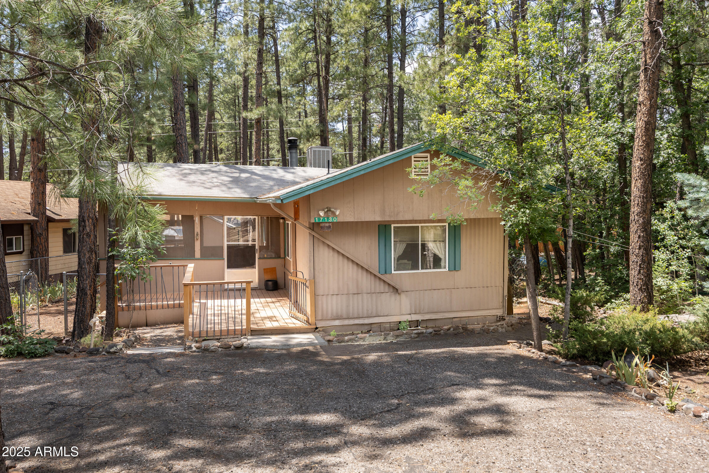 Welcome to this charming 2-bed, 2-bath manufactured home nestled in the desirable Munds Park community, moments from scenic forest hiking trails. This property offers a peaceful setting with convenient access to the outdoors, making it ideal for nature lovers & those seeking a relaxed lifestyle.
Inside, you'll find a cozy stone fireplace perfect for cooler evenings.  While the property could benefit from some updating, it presents a great opportunity to add your own style and value.
Enjoy outdoor living with a fenced yard, screened-in porch for year-round comfort, and an additional storage shed. The property also offers ample parking, providing convenience for multiple vehicles or guests.