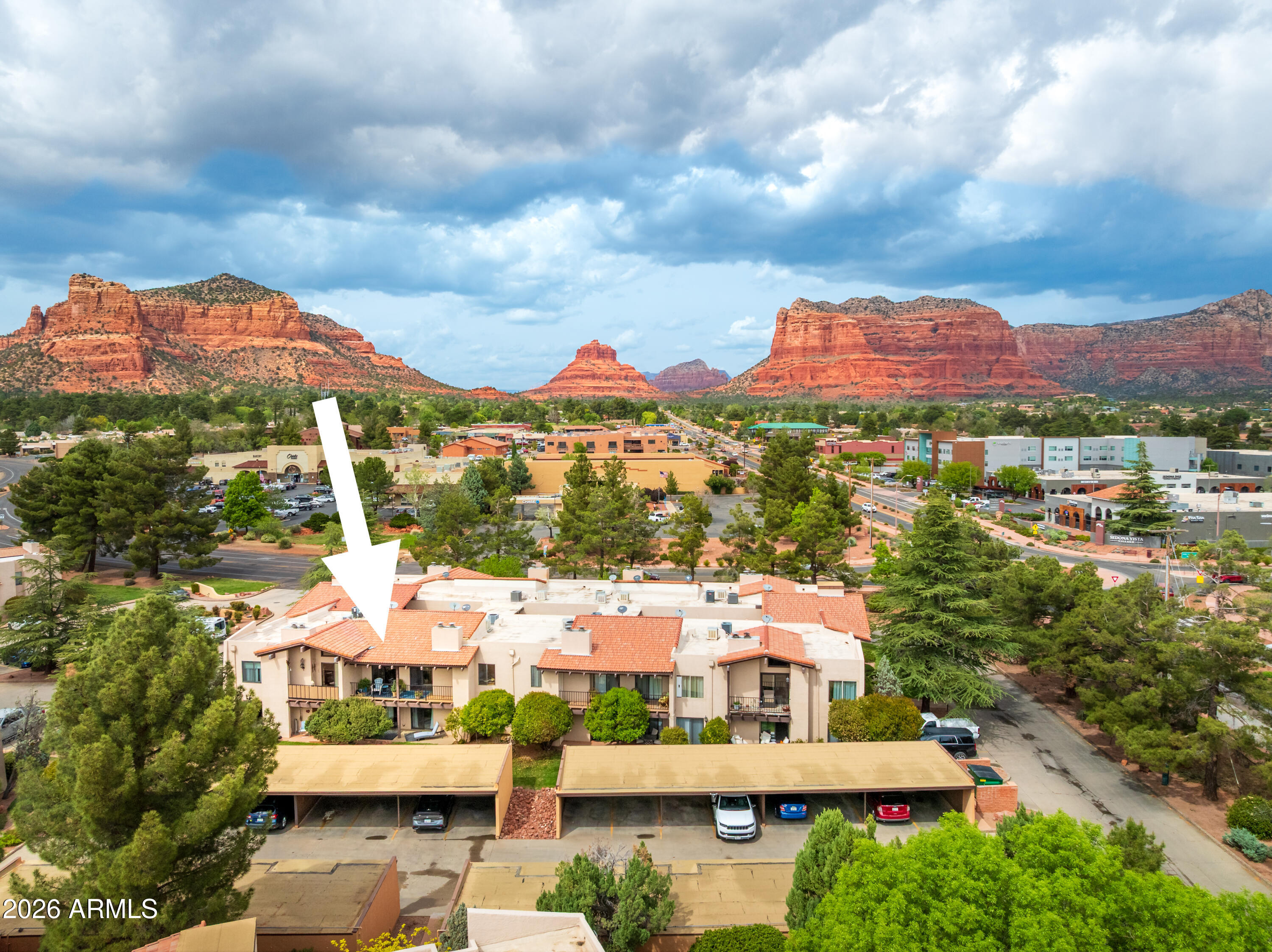 TURNKEY SEDONA RETREAT! Short-term rental friendly and offering the perfect lock-and-go option for part-time owners, this beautifully positioned second-floor condo in the heart of the Village of Oak Creek delivers both lifestyle and income potential. This 2-bedroom, 1,152 sq ft residence features vaulted wood-beamed ceilings, a cozy fireplace, and an open-concept living space filled with natural light, flowing seamlessly to a private balcony ideal for relaxing or entertaining. Freshly painted and pre-inspected for your convenience, this property is ready for immediate enjoyment or rental use. Located in a subdivision where Airbnb is permitted, additional highlights include in-unit laundry, covered parking with storage, and access to community amenities such as a pool, spa, tennis/picklebal and BBQ areas. Just steps from Clark's Market, local dining, and minutes to Bell Rock hiking trails and Sedona Golf Resort, with Uptown Sedona only a scenic 15-minute drive away--this is effortless Sedona living with flexibility built in.