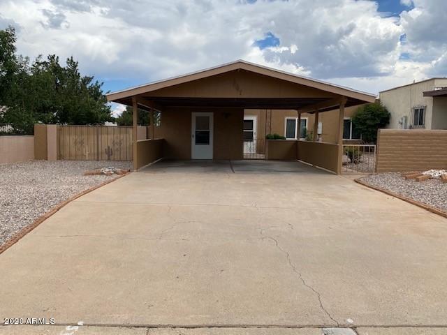 Don't miss this cute townhouse on a very large lot (2nd biggest in the  neighborhood ) with a beautifully landscaped courtyard, RV parking, two car carport and grass back yard with fruit trees. This home has 3 bedrooms, 2 baths, large living room with a fire place, a Arizona room.  Seller is offering a Home warranty for the first year.