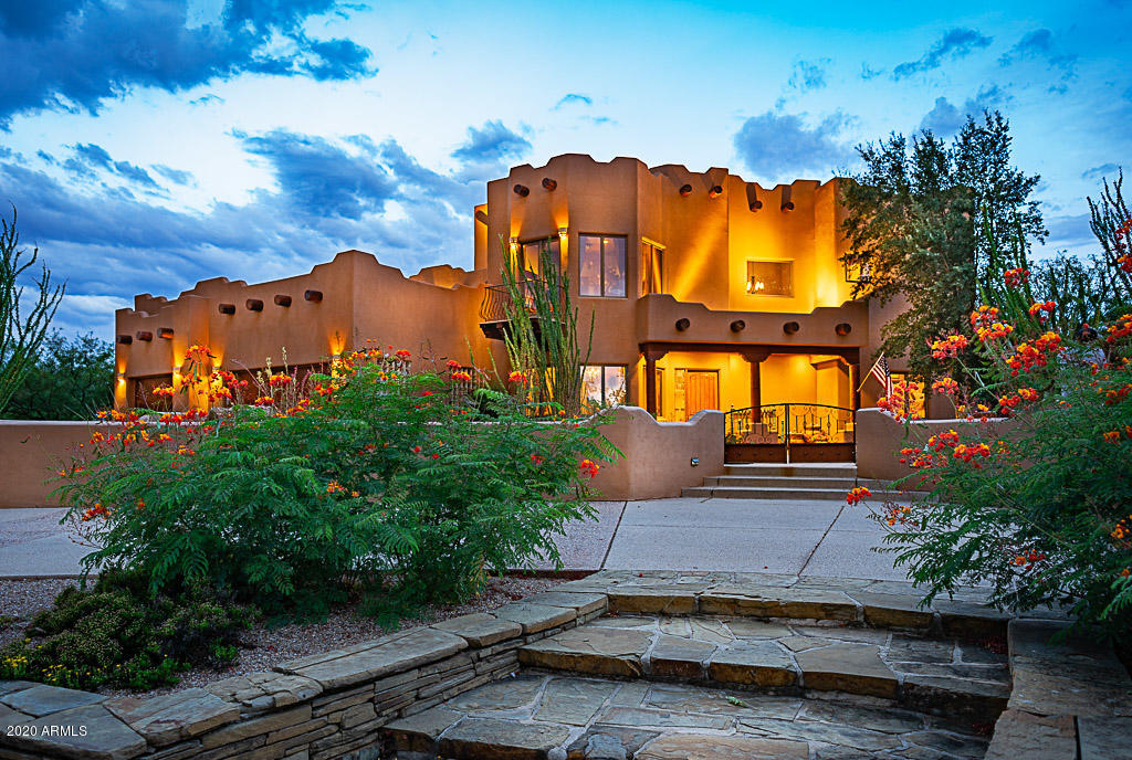 Searching for that special custom home with all the upgrades & extras? You've finally found it. Upon your arrival you will enjoy the enhanced, established native landscaping. The smell of Miller Canyon creek will greet you & entice you for a mountain hike. Coming thru the front courtyard you can feel the allure of this Santa Fe home. The floor plan is designed w/ entertaining in mind; the great room offers wide open space, 25' ceilings w/ natural wood peeler pole vigas, formal dining room, eat in kitchen, gas fireplace & stunning views. The owners spared no expense w/ solid wood doors, high end cabinetry & GE Profile Stainless steel appliances. The master suite is luxurious complete with balcony and firepit. Have a relaxing staycation in the backyard. Full list of features in the documents
