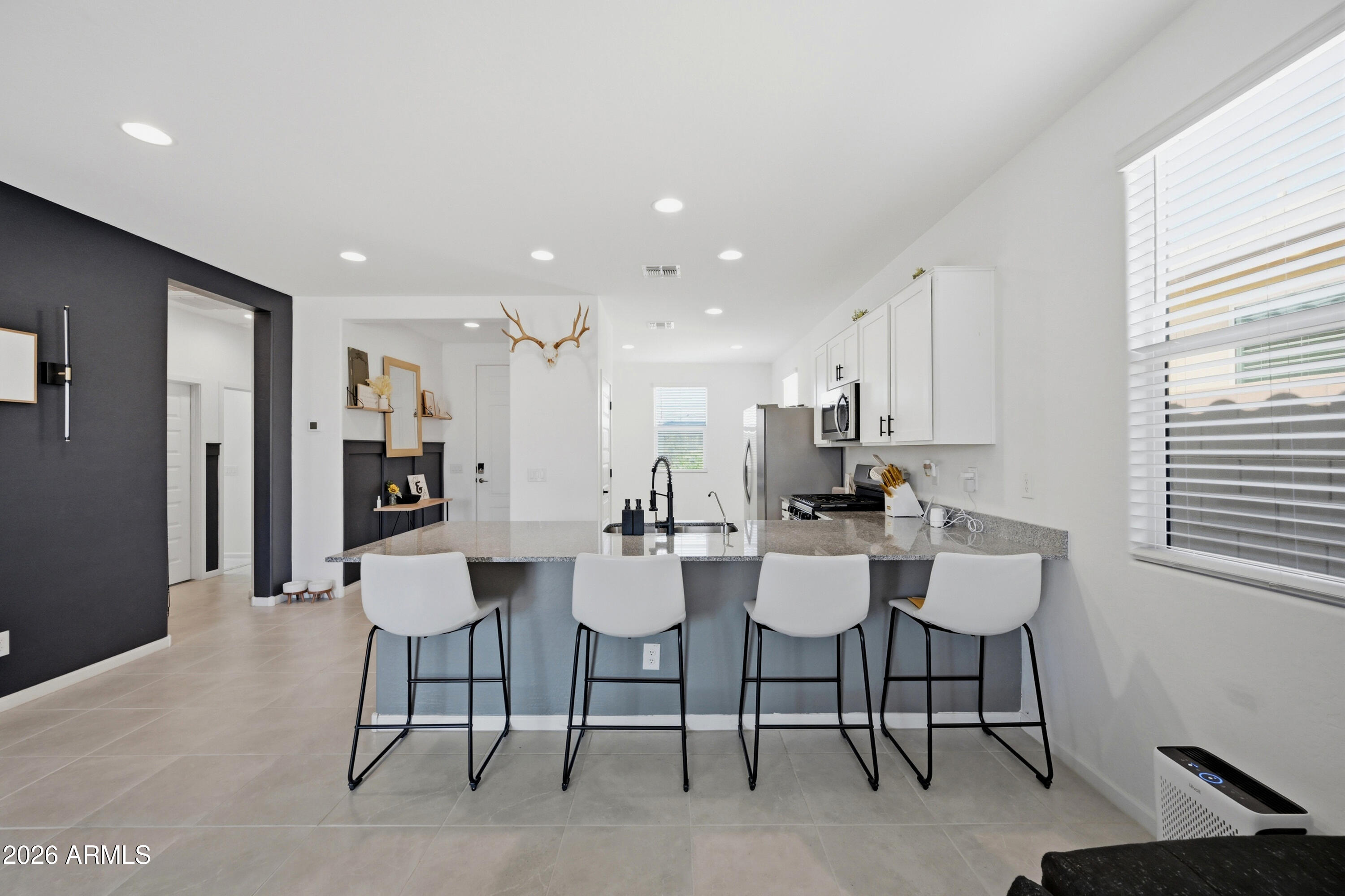 Built in 2023 by Lennar, this move-in ready home in San Tan Valley checks every box. Step inside to find 9-foot ceilings, a chef-inspired kitchen with a gas stove and clean, granite countertops, and thoughtful design touches throughout -- including a custom accent wall and shiplap detail that give this home a warm, elevated feel you won't find in every new build.
The community keeps your lifestyle going beyond your front door with pickleball courts, a resort-style pool, and a park -- all just steps away.
If you've been searching for a newer build with the upgrades already done, this is it.