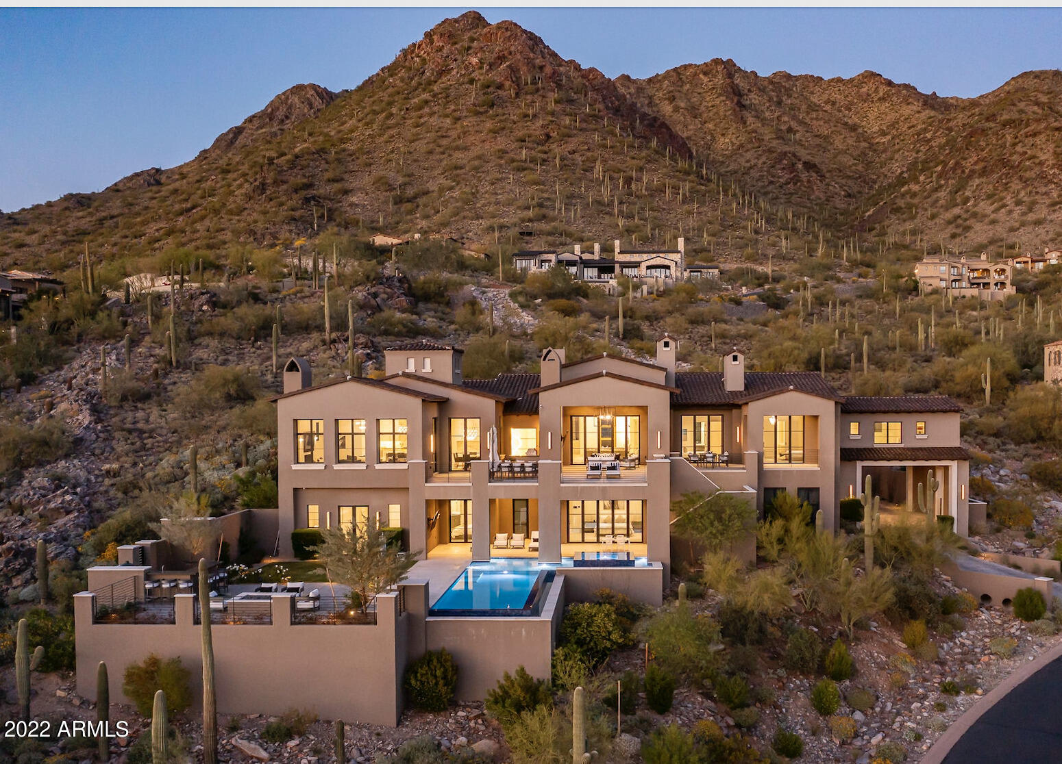 Tasteful architecture invites you into this exquisitely designed estate. This ultra-luxurious modern European-style home is a pinnacle piece in the coveted and highly exclusive Summit of Silverleaf's Upper Canyon. The allure begins as soon as you enter the driveway and is deepened upon first entry into this designer showcase. This stately home radiates sophistication offering sleek design details, hand-picked finishes, and boundless views. Boasting a 6-car garage, feature walls with imported book-matched marble slabs, sculpture-inspired light fixtures, waterfall double kitchen islands, and temperature-controlled wine storage. Behold breathtaking views of the surrounding mountains and perfectly-perched Valley views through custom Nana doors from nearly every room in this spectacular home.