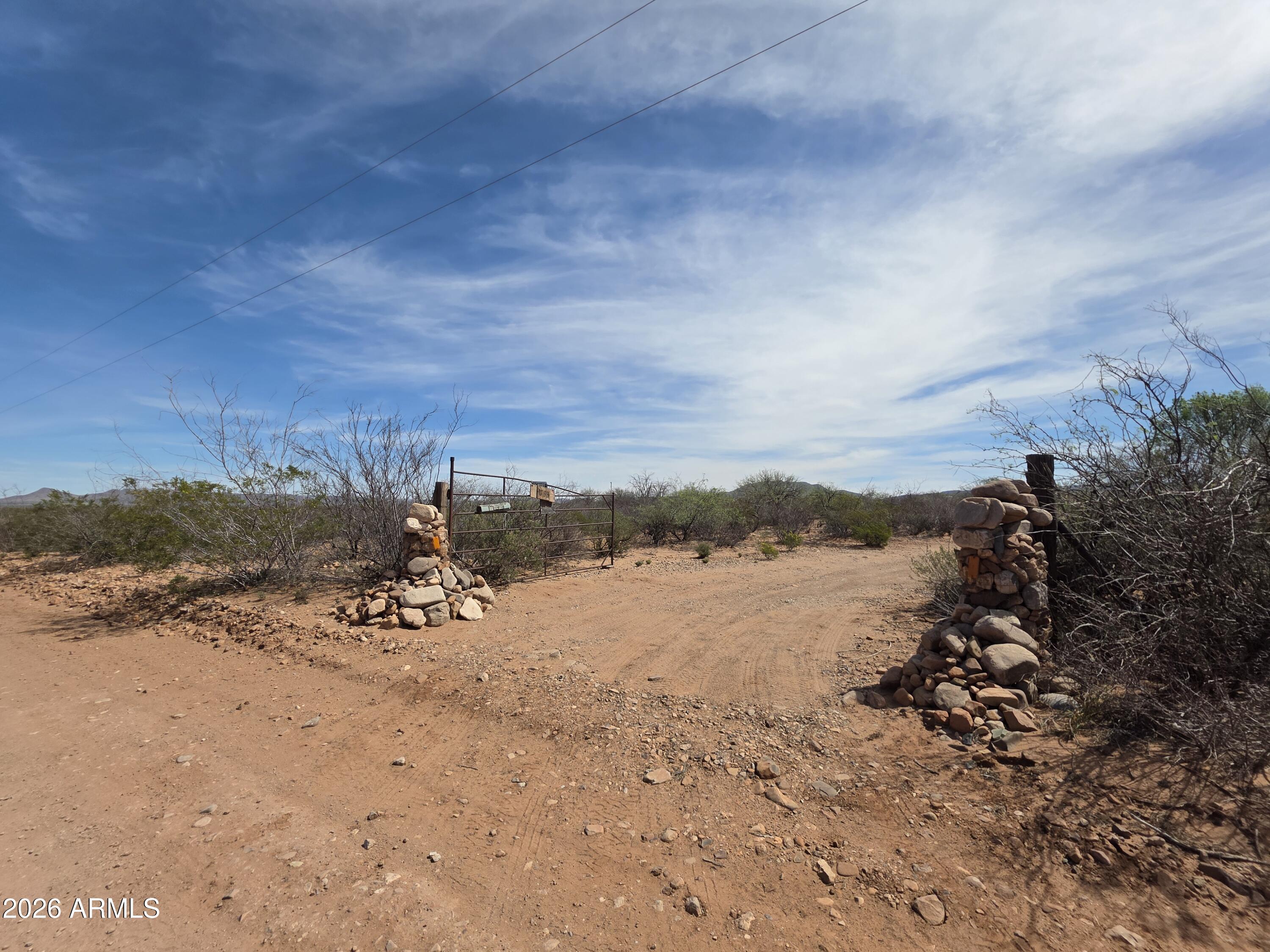 Set on 4.397 acres of private, secluded desert landscape between Sierra Vista and Bisbee--near the San Pedro River--the property features a 1981 mobile home with a 1996 addition totaling approximately 1,495 sq ft. The home requires major repairs and is being sold as-is, making it ideal for those ready to take on a project or start fresh.
Beyond the structure, the true value lies in the land and its story. The seller deeply loved this property, spending countless hours walking the land and surrounding area, Over time, pieces of the past revealed themselves--arrowheads, petrified wood, and other natural treasures--adding to the character and connection this land offers. Private well approximately 100 yards from the home
Shed & multiple outbuildings with potential for storage or workshop use-Large rock chiminea for peaceful desert evenings-
Mature trees, ocotillos, & creosote showcasing the natural desert beauty *Minimal land maintenance aside from cleanup
if you're looking for your next project or seeking land with meaning & history, this property offers a rare opportunity to create something new while honoring what once was. Sold as-is. Bring your vision & make it your own desert oasis.