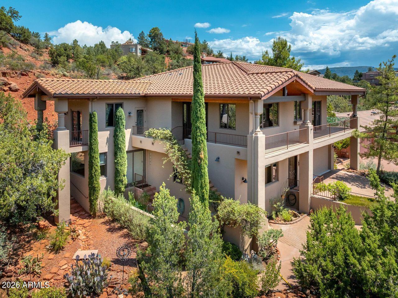 Perched to capture breathtaking Sedona red rock views, this spacious home offers comfort and exceptional entertaining spaces. The main upper level is designed for everyday living and features a well-appointed kitchen, dining area, expansive great room, all with incredible views, comfortable bedrooms, bathrooms, and laundry. An elevator provides easy access between both levels, making the home accessible and convenient. The ground level is an entertainer's dream, with a spacious media/great room, wet bar, wine room, 1/2 bath, and an oversized garage. There's more, the home includes a separate bonus room with its own private entrance on the left side of the house--ideal for flexible uses. This exceptional Sedona home offers the perfect blend of spacious living, and unforgettable views.