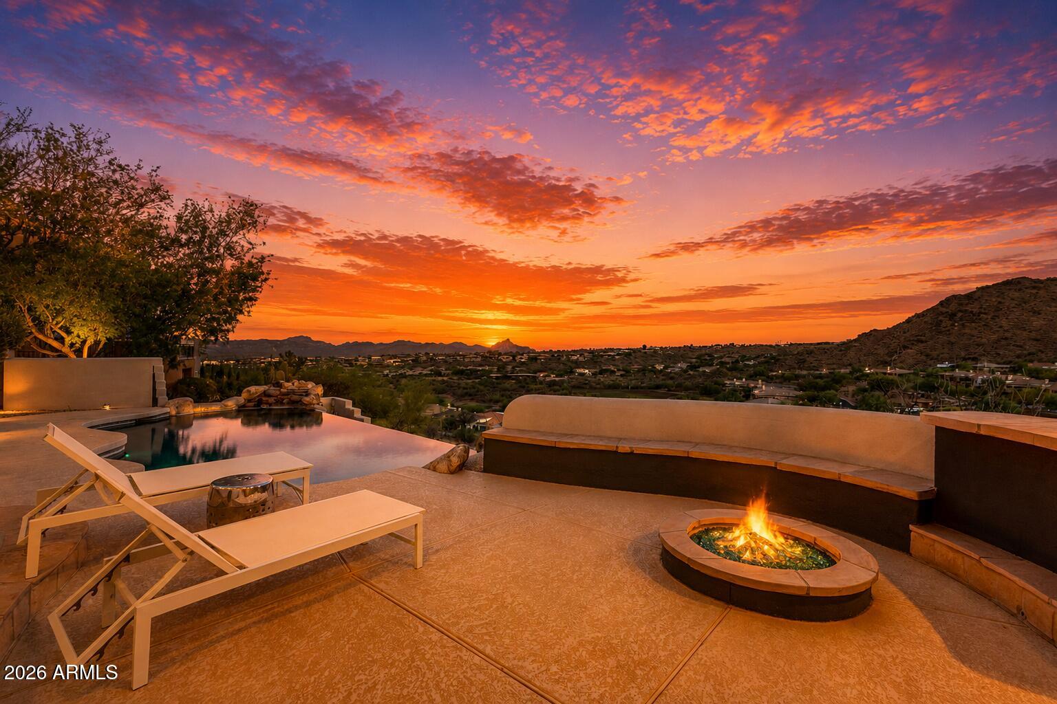 Where Every Sunset Feels Like a Celebration, and Every Night Brings the Stars
There's something different about life when every day ends with a view like this.
The pace slows. Dinner lasts a little longer. Friends don't rush home. You find yourself stepping outside each evening, not because you planned to, but because another Arizona sunset is simply too beautiful to miss, and because once the sky goes dark, the stars come out like almost nowhere else.
That last part isn't an accident. Fountain Hills is one of the world's few International Dark Sky Communities, and one of only two sitting this close to a major city. The McDowell Mountains shield the town from the glow of Phoenix, so on a clear night you can still see the Milky Way from your own backyard. And yet you're just about 30 min 30 minutes from Phoenix Sky Harbor, remote in feel, effortless in reach.
Tucked into the prestigious Sunridge Canyon community, this exceptional single-level estate was designed around the moments that matter most. Approximately 4,200 square feet total, including a beautifully appointed detached casita, it offers the perfect balance of luxury, comfort, and connection.
The backyard is where this home truly comes alive. A negative-edge pool seems to spill toward the horizon, framed by McDowell Mountain rising close to the north and Red Mountain glowing in the distance. The covered patio, outdoor kitchen, built-in grill, refrigerator, bar, and gas fireplace create a setting where birthdays become traditions, holidays become unforgettable, and ordinary evenings feel like a weekend getaway. There's even a daily gift you won't find in the listing photos: the nearby mountain draws a soft thermal breeze across the patio most afternoons, nature's own air conditioning right when you want it. And from this same patio, you'll catch the signature view of the Fountain Hills fountain, an everyday reminder of where you are.

Inside, expansive windows frame the same sweeping mountain and fountain views, filling the home with natural light. The great room, anchored by a gas fireplace, flows effortlessly into the kitchen and dining area, making every gathering feel connected. A dedicated home office offers a quiet place to work, while the entertainment lounge with its pool table quickly becomes everyone's favorite room.
The primary suite is a private retreat with direct patio access, a spa-inspired bathroom, and a generous walk-in closet, creating a peaceful place to begin and end each day.
Then there's the detached casita.
Not simply a guest house, but a space that changes with every season of life.
Complete with its own living room, wet bar, refrigerator, full bathroom, and a dedicated cinema room that doubles beautifully as a guest bedroom, it lets visitors stay close while keeping their own privacy, comfortably apart from the main living areas. Connected by its own charming courtyard with a fireplace, it can become an elegant guest retreat, a private mother-in-law suite, an executive office, a creative studio, or the dream space every teenager wishes they had.
Some homes are designed to impress. Others are designed to be lived in. This one manages to be both, grand enough to take your breath away, comfortable enough that you never want to leave.
Set on a quiet, low-traffic street where many homes are seasonal residences, it offers the calm, well-kept, lock-and-leave ease that makes Fountain Hills so sought after.
It's where grandchildren ask to spend the weekend. Where friends stay until the stars come out, and then a while longer, because here, the stars are worth staying for. Where working from home doesn't feel like work. Where every room has a purpose, but every window reminds you why you chose Arizona.
Because the most memorable homes aren't defined by their square footage. They're defined by the life that's lived inside them.
Where every sunset feels like a celebration, and every night brings the stars.