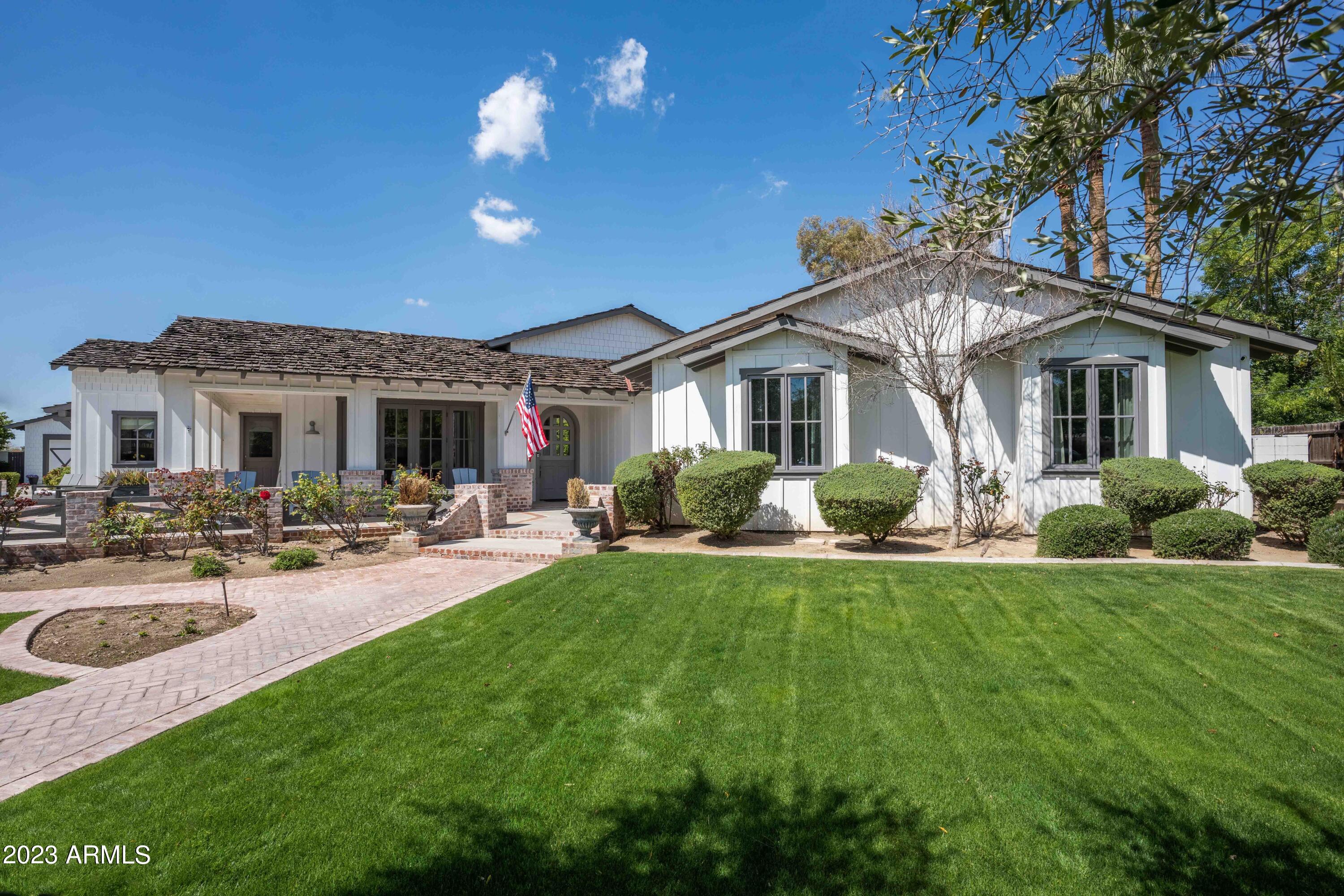 Here is an opportunity to live in the highly sought-after Hilker Estates. This custom home is ideally situated on a .64-acre lot and offers 4950 square feet of living space with an additional 516 square feet in the guest house. The home's superior craftsmanship and luxurious finishes convey warmth and sophistication. Dutch doors, wide plank oak flooring, and brick accents contribute to the Arcadia charm. The main house has an ideal floor plan with four bedrooms, four bathrooms, all of which are ensuite, a flex space, two offices, and a guest house with a kitchen, bedroom, and bathroom. Perfect for entertaining, the chef's kitchen features Thermador appliances, a large island, and a butler's pantry. The dining room adjacent to the front patio is flooded with natural light. The Fleetwood doors in the living room capture the essence of indoor/outdoor living, flowing seamlessly to the back patio centered with a brick gas fireplace. The pool, dedicated lounge area, large grassy areas, and guest/pool house make for the perfect afternoon. The basketball court is another highlight with easy conversion to a pickleball court. The oversized 4 car garage provides ample parking for all your cars and toys.
