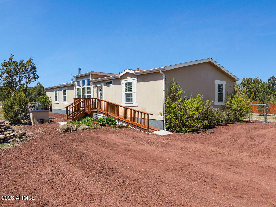 Tucked away on a full acre in the heart of Williams, this lovingly maintained 4-bedroom, 2-bath home offers the perfect blend of comfort, space, and mountain town living. Proudly owned by the original owner, the care and pride of ownership shine throughout. Inside, you'll find updated flooring, two spacious living areas, and a versatile bonus room perfect for a home office, game room, guest space, or hobby area. The large open kitchen was designed for gathering, featuring abundant counter space, an oversized island, and an easy flow into the dining and living areas ideal for both everyday living and entertaining. Vaulted ceilings and expansive windows fill the home with natural light, creating a warm and inviting atmosphere. A wood burning fireplace is featured in the first living room... The primary suite is expansive with an en-suite bath featured on a split floor plan. The remaining bedrooms are spacious with plenty of storage.  Step outside and enjoy the privacy large back deck a full acre, and a fenced in backyard offering plenty of room for outdoor living, gardening, toys, or simply enjoying the peaceful Northern Arizona setting. Located just minutes from downtown Williams and surrounded by the beauty of the trees, this home captures the relaxed lifestyle that makes Williams so special while still being an easy escape from the Valley heat and close to Flagstaff.