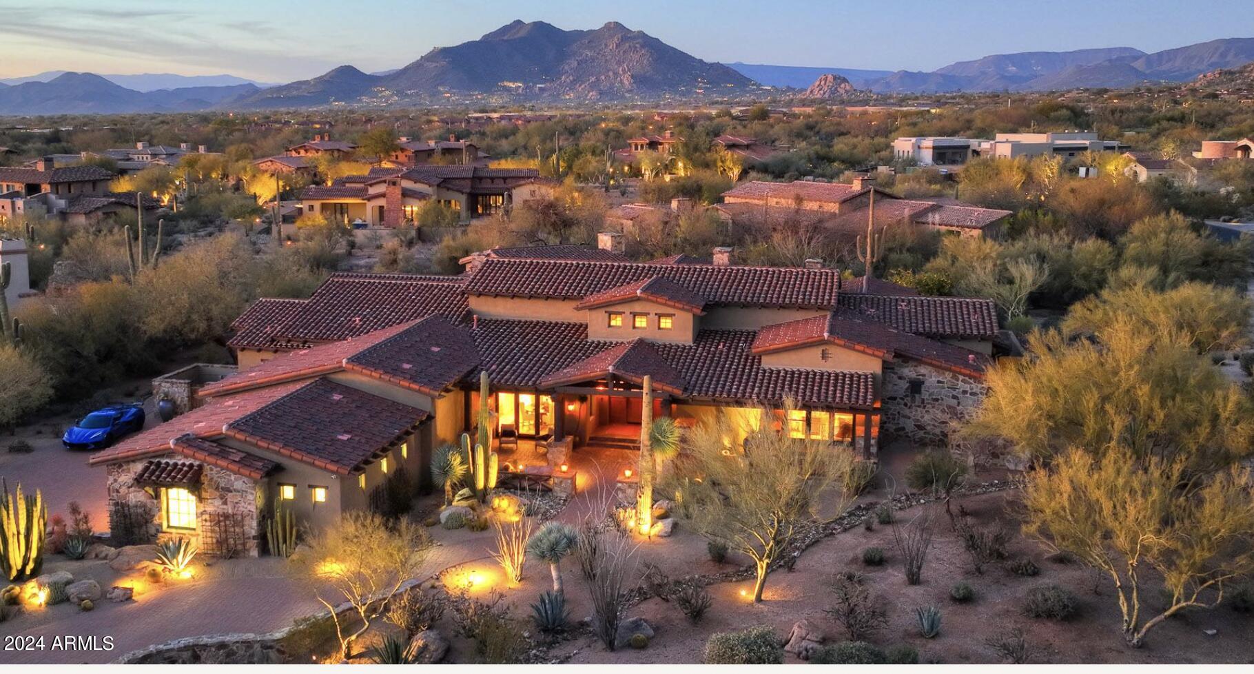 Timeless design and luxurious finishes exude the Arizona Lifestyle in this stunning home built by award winning builder Calvis Wyant. Located within prestigious Whisper Rock, the home features soaring ceilings with rough hewn beams, honed travertine and  hardwood floors, beautiful custom cabinetry and Savant smart home system. Split floor plan offers formal and casual living and dining, fantastic billiards room with wet bar, spectacular kitchen with stunning island and high end appliances, and 364 bottle wine room.  The master retreat features a luxurious spa bath, as well as an adjoining sitting/workout room looking out to the inviting backyard.  The serene office and powder room round out the east wing. Additionally 2 spacious secondary bedrooms with private baths provide luxurious... appointments for family or guests. The equally lavish guest casita with private entrance provides the ultimate in accommodations, including kitchenette and stone fireplace. The heated pool and spa and grilling/dining areas transform outdoor  living into a luxurious desert oasis. The property's interior location offers privacy and a truly tranquil setting, all within the guard gated golf community of Whisper Rock.