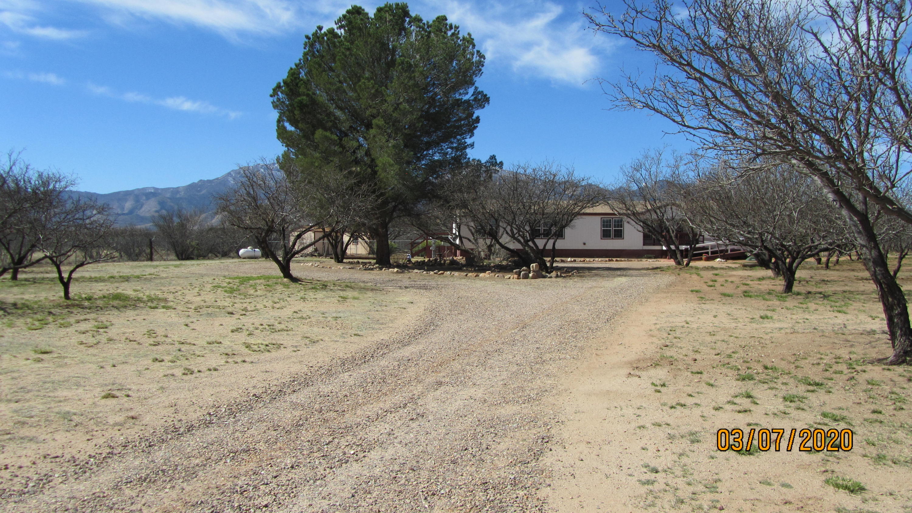 Welcome!! This spacious Triple Wide home offfers 4 Bedrooms, 3 Bathrooms, with a Garden Tub in the Master Bath and sits on 4.03 acres, just waiting to embrace its new owner.  There's lots of room to move about inside with lots of scenery outside.  Then, if you wish to entertain or relax with family and friends in style, just head to the Arizona Room and open the Bar for service or get into the Spa/Hot Tub.  Both the front and back yards offers its on character with the backyard displaying one of the largest Tombstone Rosebush in the area.  Washer & Dryer, 2 Refrigerators and 10 Bar Chairs, conveys.  Home Warranty to be added/offered.  Come see all this and more.