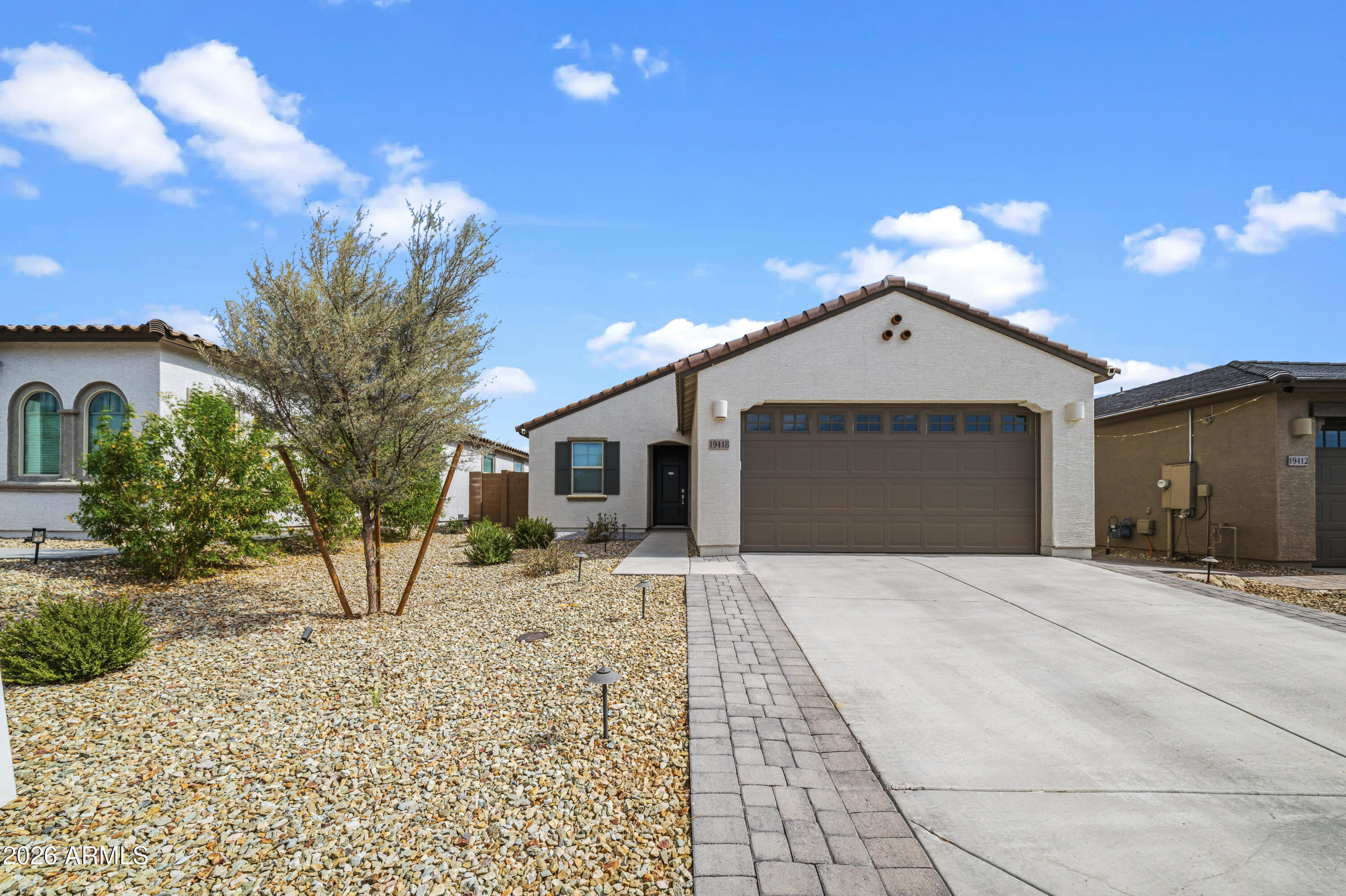 Welcome to this beautifully upgraded 2023 Lennar home located in the desirable Landings community. This move-in ready 3-bedroom, 2-bath residence offers an open-concept floor plan with modern finishes throughout. The kitchen features upgraded cabinetry, granite countertops, designer backsplash, pendant lighting, a large island, gas range, and walk-in pantry. Wood-look plank tile flooring flows throughout the main living areas, complemented by fresh interior paint and abundant natural light. The spacious primary suite includes a spa-inspired bath with an upgraded subway tile walk-in shower, dual vanities, and granite countertops. Additional upgrades include epoxy garage floors, a soft water loop, and low-maintenance landscaping. The backyard is designed for year-round enjoyment extended paver patio, artificial turf, gas stub for grilling, and mountain views. Additional curb appeal includes a paver driveway, covered front porch, and landscape lighting. Conveniently located near Loop 303, shopping, dining, parks, and highly rated schools, this home offers modern comfort in a growing West Valley community.