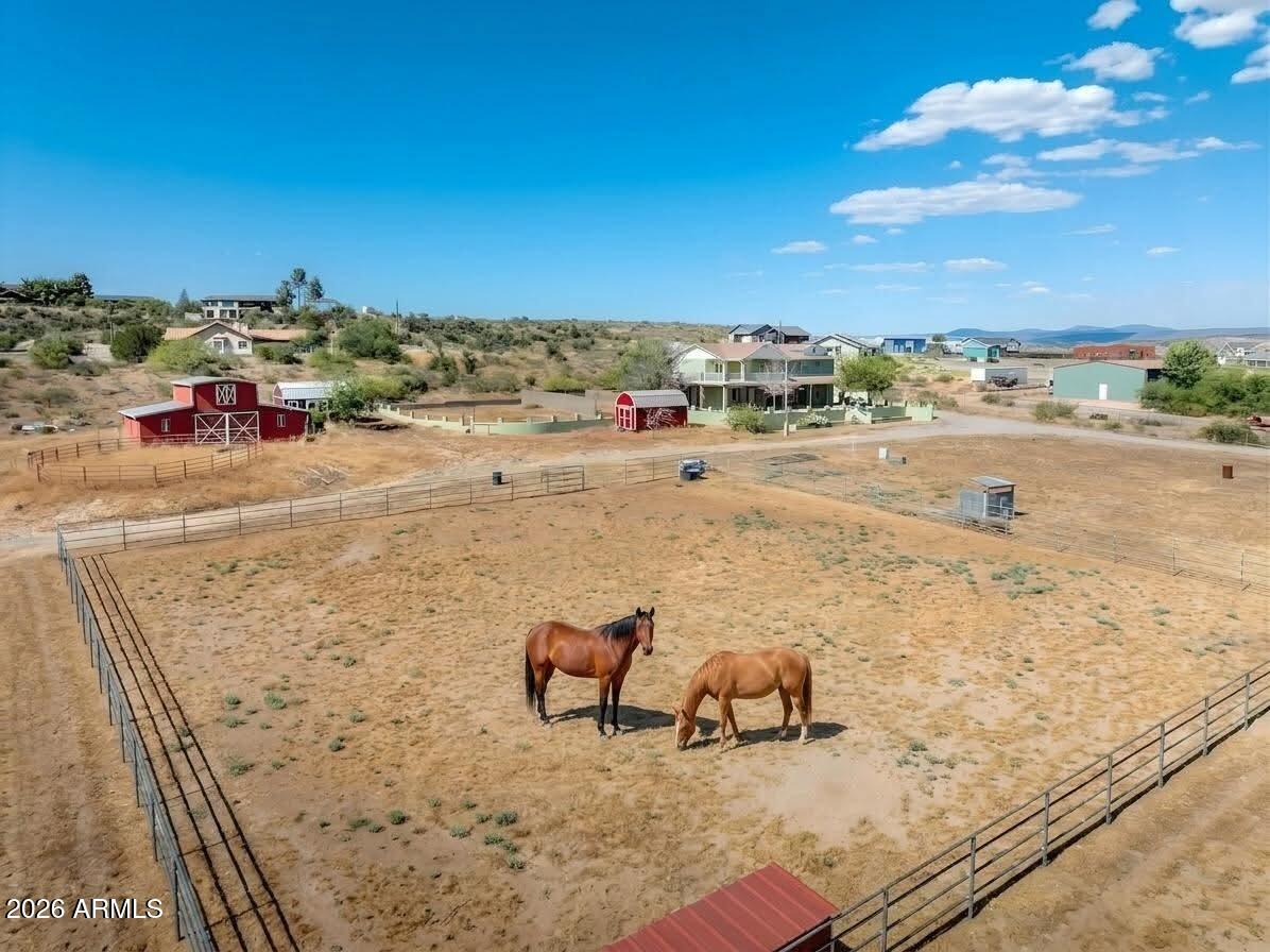 Fully equipped horse property on over 2 acres of usable land with panoramic mountain views! 1733 N Arena Del Loma offers space, flexibility, and endless potential. Set up as a working horse property, the land features a full barn, riding arena, corral, separate fenced dog run, private well, and ample room for horses, RVs, trailers, gardens, workshops, or future expansion. Wide open acreage and peaceful surroundings create the perfect setting for those seeking privacy, room to roam, and the freedom of country living.

With over 2,500 square feet of living space, the home offers a comfortable 3-bedroom, 2-bath main residence along with a separate in-law suite. Downstairs includes two living rooms, first bathroom, and spacious kitchen and dining room with bright bay windows. The upstairs bedrooms offer privacy away from the living spaces. The primary is very large with a cozy fireplace and French doors opening on to a private covered patio, looking out across the expansive valley and surrounding mountains.

The guest quarters features a fourth bedroom & living space, third bathroom, and full second kitchen. Ideal for multi-generational living, guests, rental income potential, or a private workspace, it can be accessed through the main home or through a separate private entrance equipped with an accessible chair lift for the stairs.
Ready for its next chapter, the property provides a solid foundation and blank canvas to bring your own vision and personal touches to life.

Located in historic Camp Verde near the scenic Verde River, the area offers endless opportunities to enjoy the outdoors, local wineries, hiking, kayaking, fishing, and the charm of small-town Arizona living. With convenient access to Sedona, Cottonwood, and the rest of the Verde Valley, this property offers the best of rural living with nearby amenities and recreation.