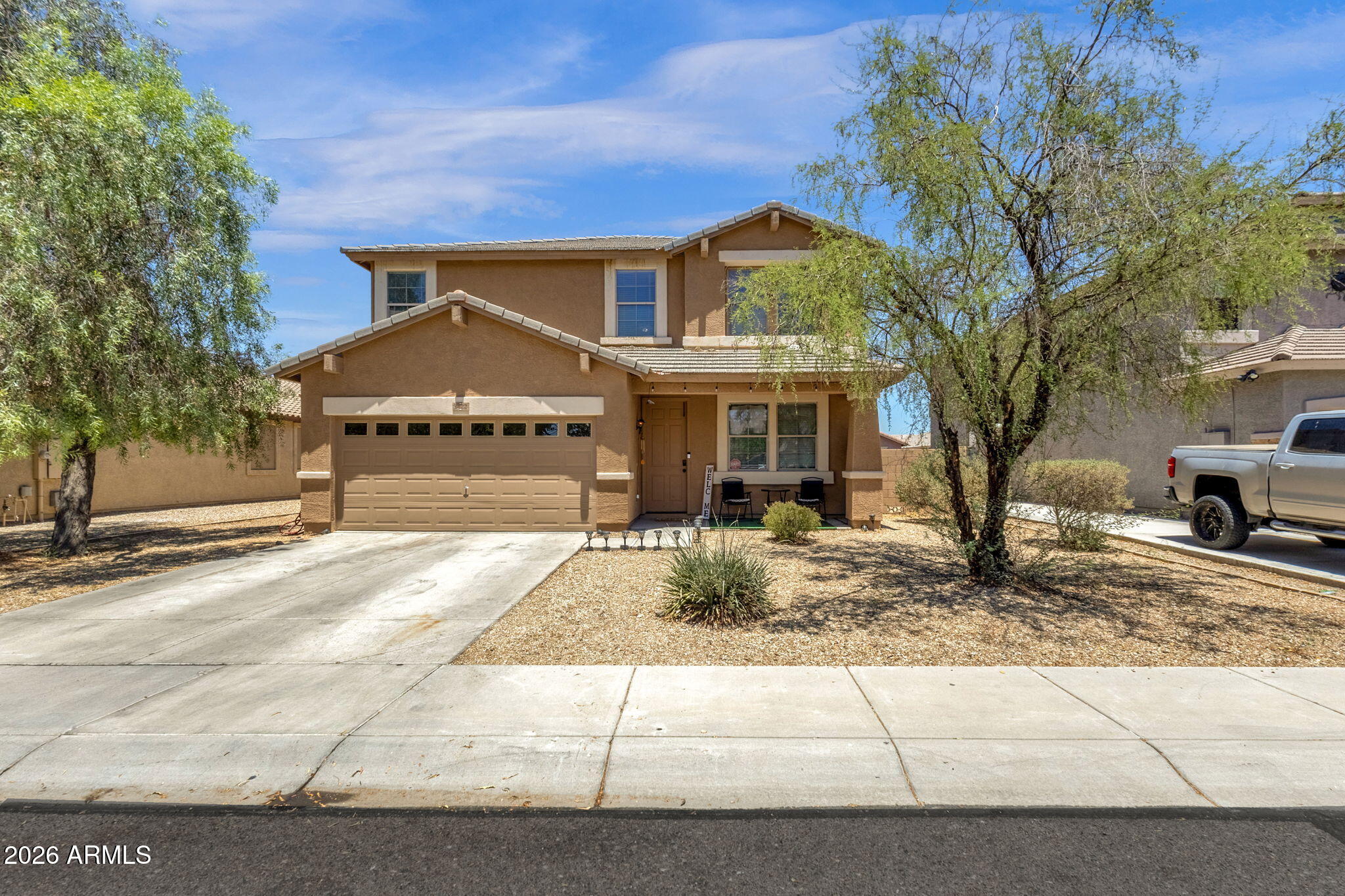 Spacious 3,181 sq ft, 4-bed, 3-bath home in Southern Views with a versatile loft flex room, great room, and covered patio. All new carpet as well as interior and exterior paint in 2025. Kitchen features an island, breakfast bar, pantry, new refrigerator in 2025, built-in microwave, and dishwasher. Primary suite includes separate shower and tub with double vanity. Two new AC units installed 2025. Two-car garage with opener. Inside upstairs laundry. Tile roof, block fencing, and desert front landscaping. HOA includes common area maintenance with biking/walking path and playground on-site. Approx. 2.5 mi to South Mountain Park. 1.8 mi to Collective Coffee. FHA, VA, and conventional financing accepted.