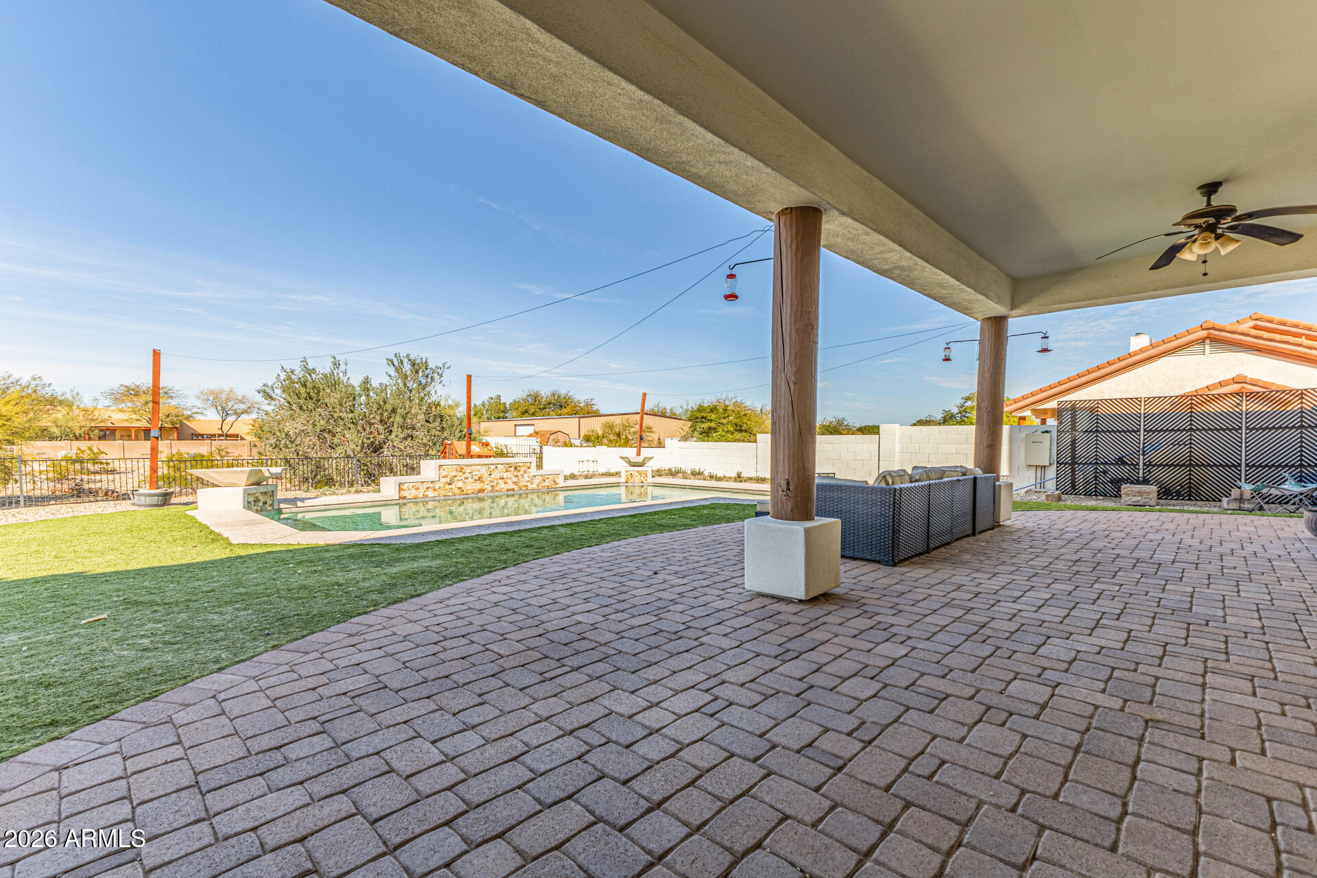 Experience the allure of this beautiful custom home with POOL & GORGEOUS MOUNTAIN VIEWS on an almost 1-acre lot! The property features an RV gate and spacious 2-car + RV garage (RV garage has additional loft storage, workshop area and attached HALF BATH)! Paver driveway for added curb appeal. The inviting interior showcases a welcoming foyer, bountiful natural light, wood-look floors in common areas/primary, and soft carpet in secondary bedrooms. Designed for everyday living, the seamlessly flowing open layout is sure to impress! The impeccable kitchen boasts SS appliances, granite counters recessed & pendant lights, a walk-in pantry, ample wood cabinetry, and an island w/breakfast bar. Primary suite has private exit to the backyard, spa-like ensuite with dual vessel sinks, walk-in closet and walk in shower. You'll love the large, entertainer's backyard! Featuring a paver-covered patio, artificial turf, a storage shed, a fire pit, and a sparkling pool for year-round enjoyment. Plus, BREATHTAKING MOUNTAIN VIEWS create a stunning natural backdrop! Bring your toys, trucks, and RVs; there's room for everything here. Zoned for horse privileges.