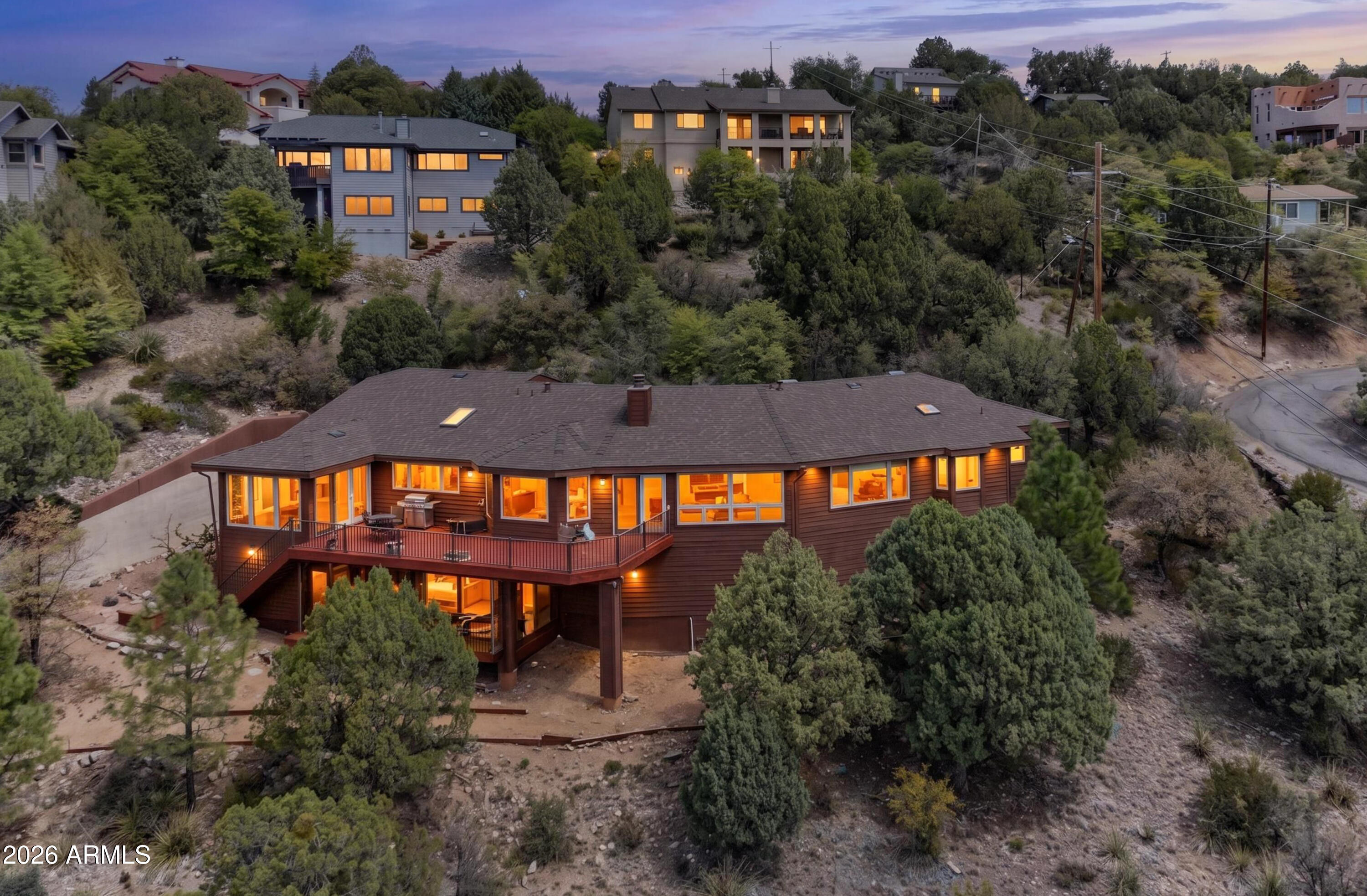 Captivating Views, Absolute Privacy, and Resort Living - Welcome to your own private sanctuary. Tucked away to offer unmatched privacy and peace, this spacious, nearly 3,000-square-foot rustic home is a truly rare find. As you step inside, your eyes are immediately drawn upward to the grand, open high ceilings that give the home an airy, majestic feel. Serving as the dramatic centerpiece of the main living space is a magnificent, double-sided stone fireplace, radiating warmth and rustic elegance throughout the heart of the home.
Designed to maximize its breathtaking valley views, the residence features a spectacular array of clear windows and skylights that flood the space with natural light. Because of the home's thoughtful elevated positioning and sloped driveway, you can enjoy these enhanced sweeping views in complete solitude, without anyone being able to look inside. 
Deeply loved, this property seamlessly blends this rustic grandeur with modern luxury. The kitchen has been beautifully remodeled, featuring gorgeous granite countertops and premium stainless steel appliances. The abundance of space continues into the large bedrooms, which boast custom closets packed with built-in shelving, while the master bath offers a brand-new, deep soaking tub perfect for unwinding.
Step outside onto two giant redwood decks to take in the scenery, or tend to the beautiful garden, which features an established annual bounty of tomatoes robust enough for home canning. Rest easy knowing the home features a BRAND NEW ROOF IN 2026, new gutters, and an HVAC system that is only a few years old. To top it all off, the community HOA offers a resort-caliber lifestyle with access to a sparkling pool, pickleball, an activity center, and festive holiday events. This isn't just a house; it's a sweet, deeply cared-for retreat ready for its next chapter.