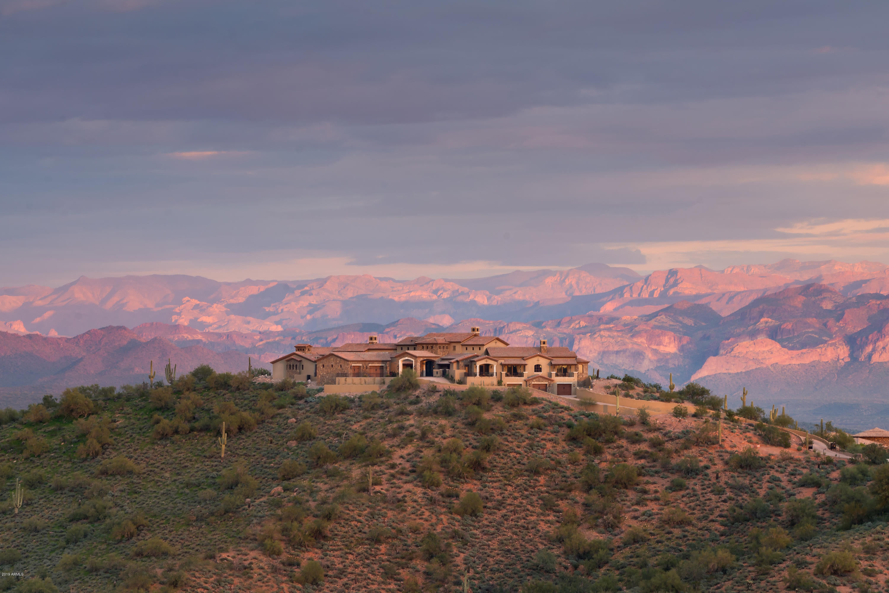 5 acre one-level Firerock residence. ''House on the Hill''

360 degree unobstructed private views of Four Peaks, Red Mountain, Phoenix Valley, McDowell Mountains. 

Distinctively designed for active living - master chefs, wine and car enthusiasts, golfers, gamers, readers, and workout fanatics will all be challenged to excel.

Exclusive luxury with handcarved cabinetry, Limestone mantels, Tabarka  & reclaimed French tiles, rustic Oak flooring. Barrel & Coffered ceilings.

North wing: Master Suite. His and Hers Offices, 2 oversized Gar bays

South wing: 3 Suites, Library, Kit, Game Rm, Fitness Rm. 4 oversized Gar bays. Golf simulator.

2700 sft of luxury outdoor living. Expansive putting green. Eight lounging areas near the negative edge pool.

6+ Garages!!
