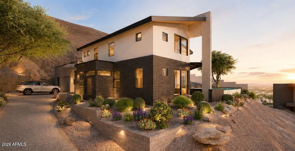 A rare, shovel-ready luxury homesite awaits in the exclusive gated enclave of Mount Central Place. This exceptional 8,712-square-foot hillside lot offers an opportunity that's nearly impossible to find--newly issued City of Phoenix building permits and fully HOA-approved architectural plans are already in place, allowing you to break ground immediately while avoiding the typical 12- to 18-month design, engineering, and approval process.
The striking contemporary residence has been thoughtfully designed to maximize the property's dramatic setting, featuring 2,380 square feet of sophisticated living space, an oversized under-roof two-car garage, and a spectacular infinity-edge pool positioned to capture panoramic views of the Downtown Phoenix skyline and surrounding mountain ranges. Floor-to-ceiling glass, seamless indoor-outdoor living, and modern architectural elements create a one-of-a-kind luxury retreat.
Set within one of North Central Phoenix's most sought-after gated communities, residents enjoy resort-style amenities including a heated community pool, tennis courts, and direct access to miles of scenic hiking and biking trails. Surrounded by luxury homes and offering unparalleled convenience to premier dining, shopping, and entertainment, this is a rare opportunity to bring a custom dream home to life without the lengthy entitlement process.
Whether you're an end user seeking an extraordinary homesite or a builder looking for a streamlined luxury project, this permit-ready property delivers exceptional value, breathtaking views, and an unmatched head start in one of Phoenix's premier hillside communities.