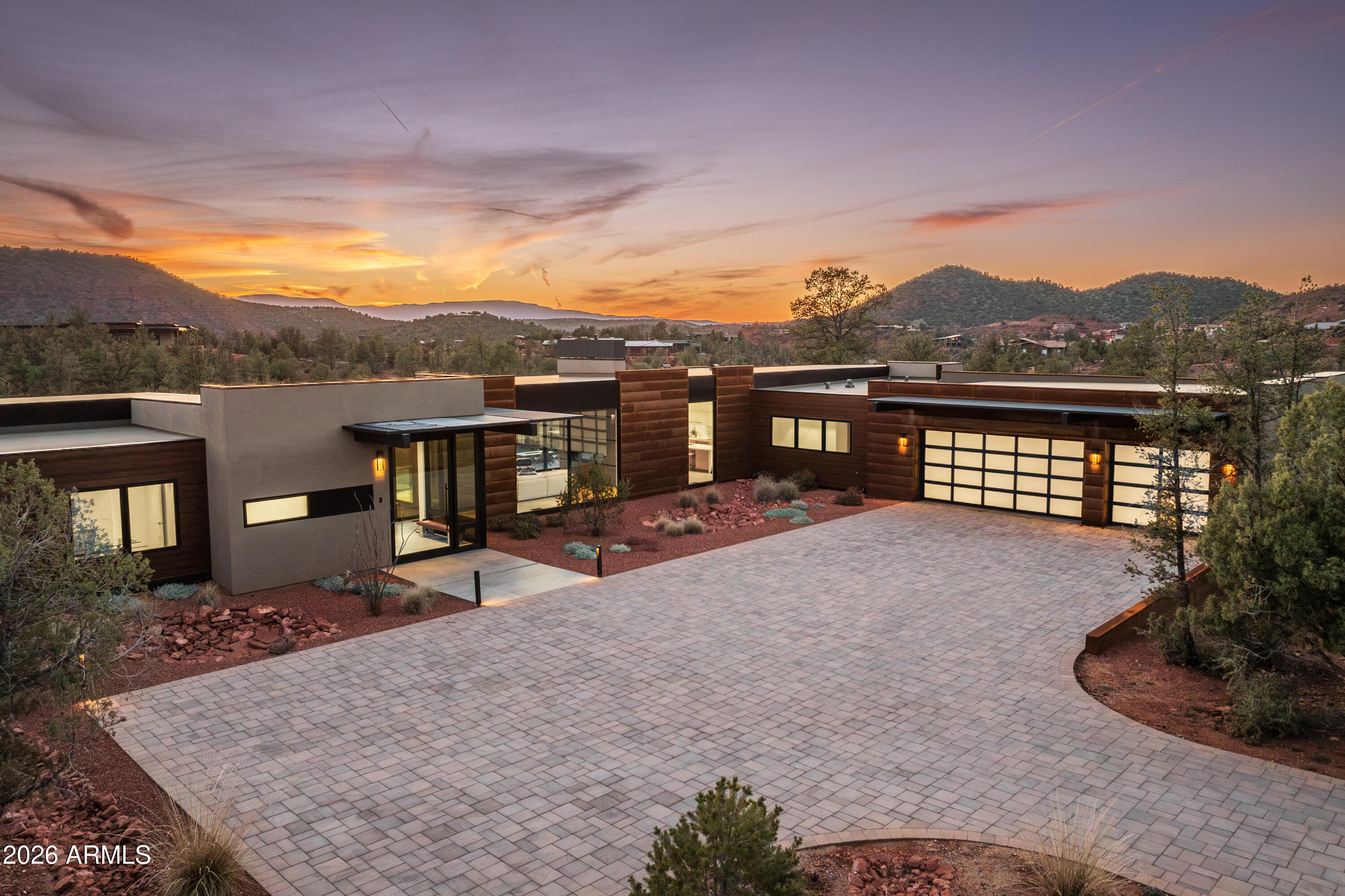 BRAND NEW masterpiece of modern design in the heart of Sedona's exclusive Cross Creek Ranch. Experience the best of modern glass home living in this 3,443 sq. ft. 4 bedroom, 4 bath pool home on 2 acres, designed by Sedona's premiere architect Freddie Valdez & built by Randy Toogood. Welcome to 15 Harvest Lane. Where the ultimate in sophisticated living harmonizes seamlessly with the Sedona's high desert and endless views toward Verde Valley's Mingus Mountains. Where home is a work of art unto itself. Where you can commune with nature from every room, through floor to ceiling expanses of glass that open up to the outdoors. In a community where you can walk to the jewel of Oak Creek, or head out on countless trails into vast expanses of National Forest land. It's all here, waiting for you. The journey begins as you pull up to the expansive motor court and view the perfectly detailed, clean lines of the home emerge from the desert landscape. You'll enter the home through a massive glass door, to be greeted by the shimmering pool and hot tub, overlooking views out to the undulating hills of Sedona's Red Rock country. The living, dining and kitchen enjoy the same views through long walls of glass that glide open to access the elevated deck that defines the outdoor space of the home. Pull a chair up in the living room next to the 6 foot linear fireplace, or enjoy the same fireside views from the dining room. The kitchen features the same huge views, and is equipped with a suite of clean-lined, professional Thermador appliances. Euro Style cabinetry with slab front doors and drawers marries perfectly with Calacatta Maximum and Blizzard quartz counters. There is a generous walk-in pantry, approx. 6' x 7', conveniently located just off the kitchen.

The primary bedroom occupies one wing of the home, and its two walls of glass capitalize on the intimate connection of the home to the nature outside. At the other end of the home are three additional bedrooms, each with their own private ensuite. Large format 24" x 48" porcelain matte tile flows throughout the living areas and bedrooms, for easy desert living. The mudroom and the laundry room are two highly functional areas of the home, each offering an abundance of convenient storage space. Garage lovers will appreciate the perfectly executed design here, finished to interior standards, and measuring approx. 38 feet long and 27.5 feet deep. There is room at the back of the garage for workshop space, and another wall of windows for the hobbyist to enjoy the views.

The 120 foot long rear deck of the home is a star in its own right, and runs nearly the full length of the house. One end of the deck features the built-in BBQ with granite counters, conveniently located just off the kitchen. The deck also features a Prism gas fire table, an ideal gathering spot for enjoying evenings under the stars in Sedona's dark sky community. The pool and integrated hot tub offer opportunities for both sun and shade with the innovative use of slatted screening along the deck. Two of the guest bedrooms enjoy their own deck area, which also connects to the pool.

The amenities of the community of Cross Creek Ranch are abundant. Each of its 81 lots are a minimum of 2 acres, to afford residents both space and privacy. The community is surrounded on three sides by Oak Creek - one of Arizona's greatest treasures. Numerous trails in the community lead down to the creek, where you can enjoy a lush, riparian habitat in the desert Southwest - truly an amazing experience. Cross Creek Ranch backs to US National Forest land on one side, and Red Rock State Park on another, with additional trails accessing vast expanses of hiking and biking opportunities. Private, gated, and exclusive, Cross Creek Ranch is the premiere development in Sedona for outdoor enthusiasts and nature lovers. It is located off Red Rock Loop Road, in a country setting, and yet is only a 10-15 minute drive to West Sedona restaurants, shopping and activities.

This extraordinary home presents a rare opportunity to purchase a brand new home in the heart of Sedona's most spectacular scenery, built by Randy Toogood, the most highly regarded builder in the Sedona/Verde Valley area, with a 40-year legacy of distinctive homebuilding.

Additional features of note:
- Catalina Stone pavers on driveway and auto court
- Trim-Trex Architectural Z Shadow Bead drywall to floor interface
- Large format 24" x 48" matte porcelain tile - main living areas and bedrooms
- Polished porcelain tile - primary bath
- Heat&Glo Primo 72" linear gas fireplace with ebony media
- Thermador 24" column refrigerator and Thermador 24" column freezer
- Thermador Freedom 36" induction cooktop (pots can be located anywhere on cooktop)
- Thermador 30" single oven
- Thermadoor 30" microwave drawer
- Thermador Emerald dishwasher
- Electrolux washer & dryer
- Coyote 36" built-in BBQ grill
- Euro style slab doors and drawers in Kitchen and all Baths, built by - Tim Cook Custom Cabinetry
- Calacatta Maximus and Blizzard quartz counters
- Solar rough in - for future install of panels
- Rheem Professional Prestige Hybrid 80 gallon water heater
- Whole house humidification system
- Whole house water softening system
- Grohe kitchen and bath fixtures
- Minka Aire ceiling fans
- Driveway measures roughly 14' x 149'
- Motor court measures roughly 33' x 79'

Additional Cross Creek Ranch Amenities:
- New fiber optic high speed internet service throughout the community
- Private sewer and water supplied by the HOA

30 Day rental restrictions in Cross Creek Ranch, no short term rentals allowed. Furniture package available with a separate bill of sale (not included in the price).