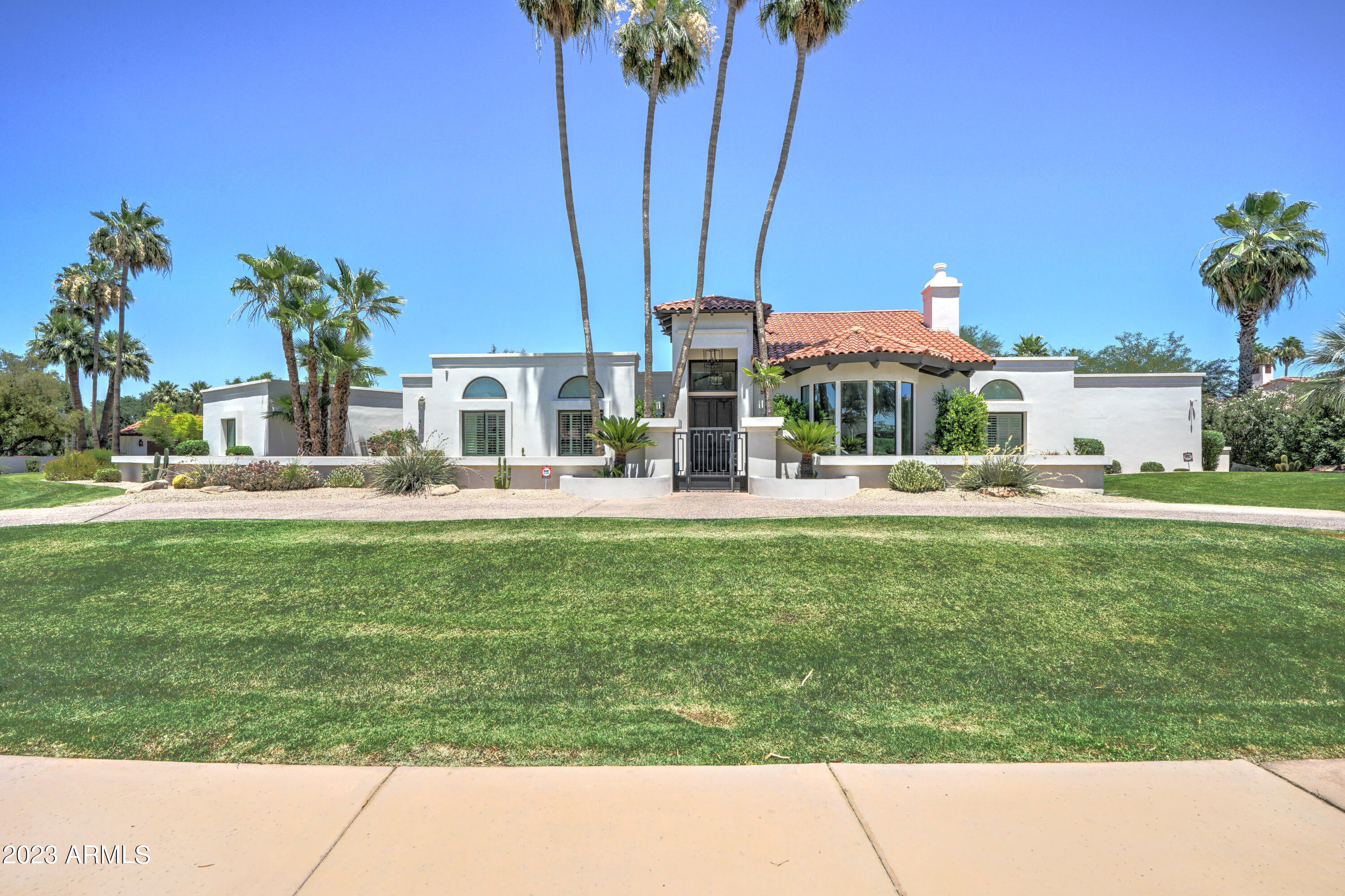 Fabulous completely remodeled Camelback Country Estates home in this quiet tucked away location in this highly desired Paradise Valley enclave of beautiful estate homes! Huge pride of ownership in this custom classic Santa Barbara style beauty featuring soaring high ceilings & hand sawn wood beamed ceilings in the formal living room & great room!  Oversized rooms & stunning architecture come together in this incredible custom home to create a truly special place!  The dream kitchen features a highly upgraded Thermador stainless-steel appliance pkg including double refrigerator & freezer, double wall ovens and a 5 burner gas cooktop! The palatial primary bedroom features a fireplace in the sitting area & a fabulous view overlooking the lushly landscaped resort style backyard.  The totally remodeled primary bathroom is simply gorgeous & features separate soak tub, double sinks, stunning walk-in shower, separate water closet + 2 separate HIS/HER walk-in closets. The secondary bedrooms are very spacious & all ensuite with their own remodeled bathrooms!  The great room is a true stunner w/ soaring high ceilings featuring hand sawn wood beamed ceiling detail & a fabulous stone surround fireplace! Buyers will love the gorgeous French Oak wood flooring throughout this custom home! Incredible AZ outdoor living & entertaining in this resort style backyard with a huge saltwater diving pool & separate heated spa!   Poolside ramada is a delight for entertaining in the shaded comfort of your private resort style setting! Lushly landscaped exterior is beautiful. Newer roof w/ warranty!  Newer Trane AC units w/ warranty!  New smooth stucco exterior finish!! This custom remodeled Santa Barbara beauty in this stunning Camelback Country Estates enclave of all beautiful estate homes everywhere you look won't be on the market long...hurry...don't miss out!