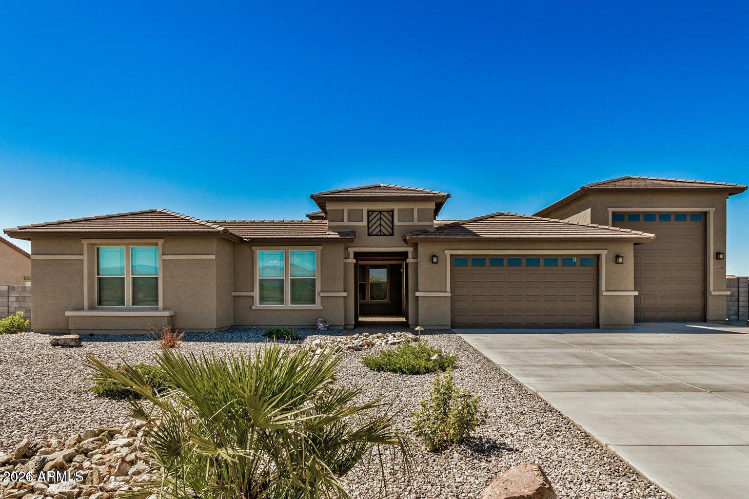 Single-Story,  3198 sqft  on a 1 acre lot  with 3 Bedrooms, Flex Space, 2.5 Baths. Four-Car Tandem Garage + RV Garage.   The RV Garage is 15' x 50' with at 14' tall door on it. Spacious open kitchen, 42'' cabinets, granite countertop, huge kitchen island,  stainless steel appliances, large owners suite! Solancia Ridge features quality new homes on one-acre homesite with attached RV garages, bring all your toys!! Pristine desert surrounding makes Quick access to major freeways and less than 30 minutes from Lake Pleasant!  All Photos are of a Model Home not the actual home. Seller paid closing costs and rate buydown available with preferred lender VIP Mort.  To be built, buyer to select structural options and design options.  Pricing will change when this is done.  6-8 months to build