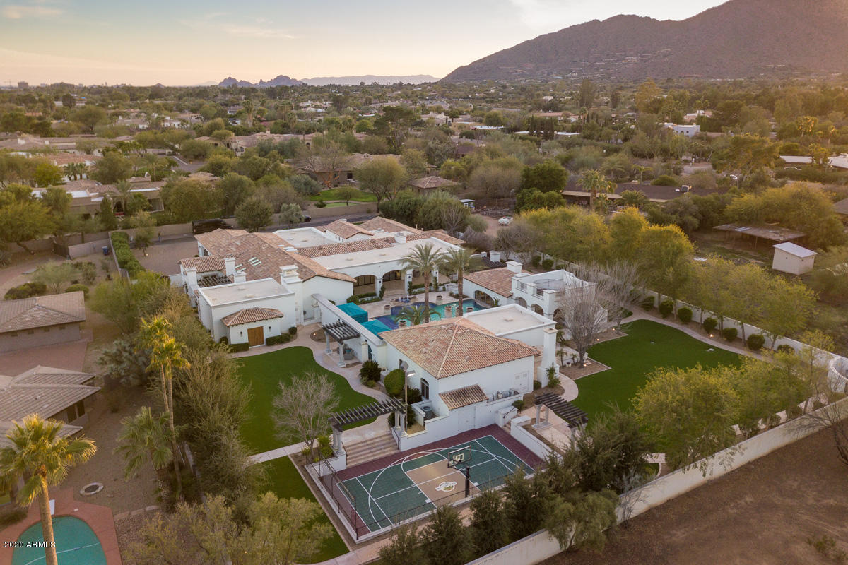 This beautifully updated private estate sits in the heart of Paradise Valley on 1.4 acres. This resort styled home features 5 ensuite bedrooms  w/an 1,088 sq ft guest house that includes a full kitchen, great room, 1 bed/1 bath and stackable washer & dryer. Swim up pool house/bar is over 800 sq ft, 2 temp controlled resort styled cabanas & misting systems will help keep everyone cool year round. Home includes a large theater room w/stage, guest suite, temp. controlled wine room, kids playroom, arts/crafts room, his/hers closets, Mr. Steam aroma therapy steam shower, heated floors in master, soaking air tub and Toto Neorest toilet... See supplement