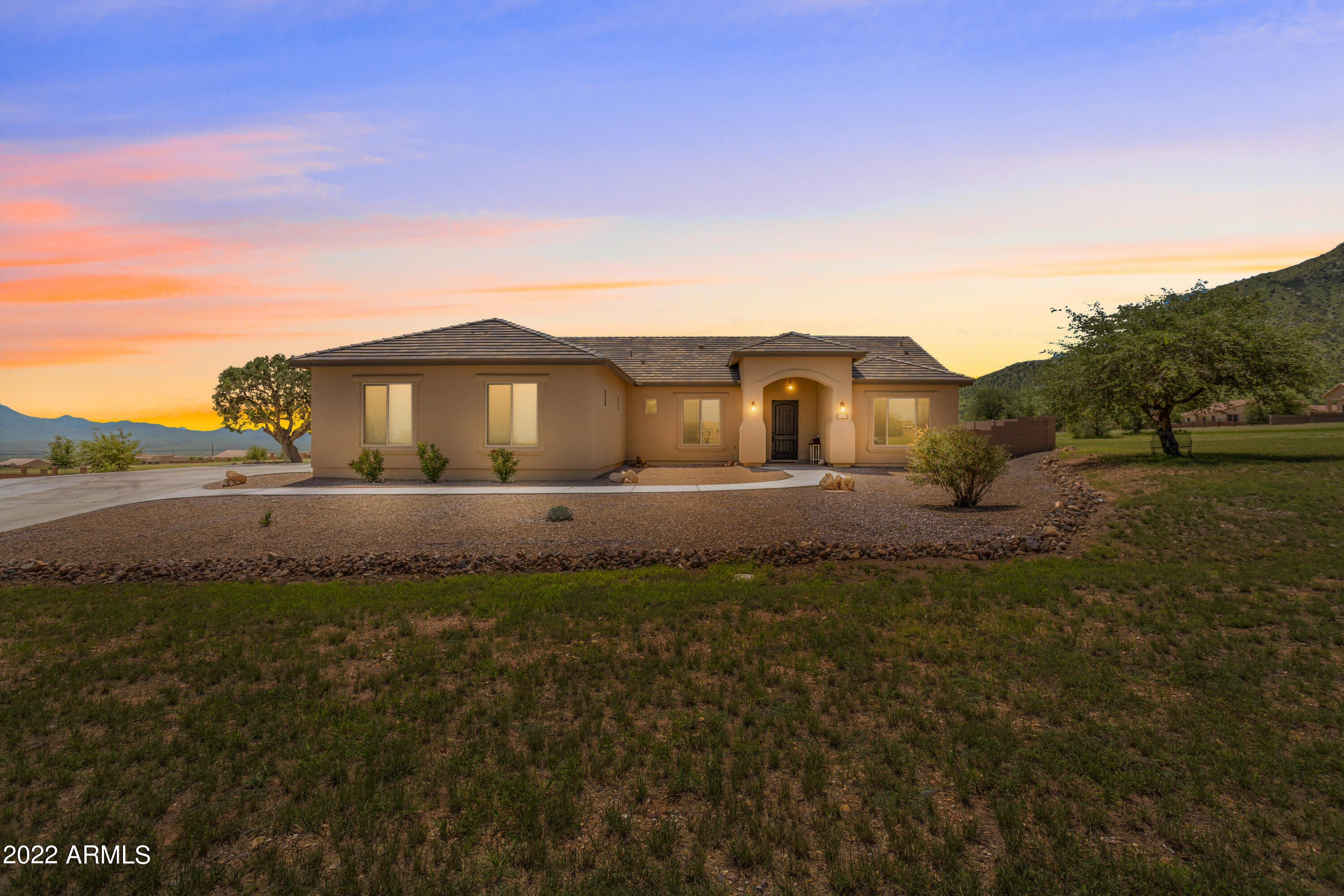 STOP YOUR SEARCH here is YOUR HOME! This gorgeous home is only 4 years old and has been beautifully maintained. Interior is newly painted, backyard has got a facelift with new block wall, grass area with sprinkler system, concrete walk way as well as extended driveway and patio. Majestic mountain views all around the home. Inside you will find 4 bedrooms and 2.5 bathrooms. 3 bedrooms have walk in or step in closets and 1 bathroom is Jack and Jill style between   two bedrooms. Living room, dining area and kitchen are all open concept with gorgeous finishes in the kitchen with granite, tile backsplash and walk in pantry. Laundry is sweeter in this large laundry room. House has wood like tile through out with bedrooms having carpet. Its a show stopper come see.