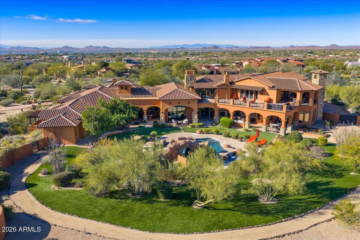 Behind the guarded gates of Prado Estates-Scottsdale's most coveted acreage community lies a Mediterranean masterpiece where luxury, privacy and panoramic beauty converge. Set on over 4 acres, on an elevated lot in North Scottsdale, this fully reimagined estate commands sweeping mountain vistas and shimmering city lights, offering an extraordinary lifestyle rarely found in today's market. An extensive, to the studs remodel, in 2023, encompassing over 1 million dollars in updates, blends timeless craftsmanship with modern refinement. Spanning more than 12,500 square feet, the estate includes a grand main residence and private guest house, each designed to offer comfort, elegance and independence for family and guests alike. From the moment you enter in the secluded Tuscan style courtyard, serenity unfolds. Inside, soaring beamed ceilings, rich stone and wood floors, and dramatic fireplaces create warm yet sophisticated living spaces. The gourmet kitchen equipped with Wolf and Sub-Zero appliances anchors the home, flowing seamlessly into expansive living and entertaining areas.The primary suite is a private sanctuary, featuring a spacious sitting room, a spa-like en-suite bath, and colossal walk-in closets.

Designed for both grand gatherings and intimate moments, the home features a private theater, spa level fitness room, wine room, office and a remarkable bar and gameroom unlike anything in Scottsdale. Despite the home's two level design, effortless living is ensured with a private commercial grade elevator providing seamless access throughout.

Outdoors, the estate transforms into a private resort. A custom diving pool with slide and spa shaded ramada, putting green and 3 observation decks create boundless opportunities to entertain or unwind all framed by Arizona's most breathtaking scenery.

Car collectors will appreciate the exceptional garage accommodations this estate provides. Featuring an expansive 7-car garage with generous storage and ceiling height ideal for a virtual golf simulator, the space is both functional and impressive. the oversized lot also offers ample room to construct an additional 20+ car showroom, creating the ultimate private automotive compound. Close proximity to Scottsdale's finest dining, shopping and Loop 101 access, this estate personifies the ultimate expression of Scottsdale's luxury living.This rare combination of a private, amenity-rich estate and an accessible, prime location makes this property an unparalleled offering in the Scottsdale luxury market.