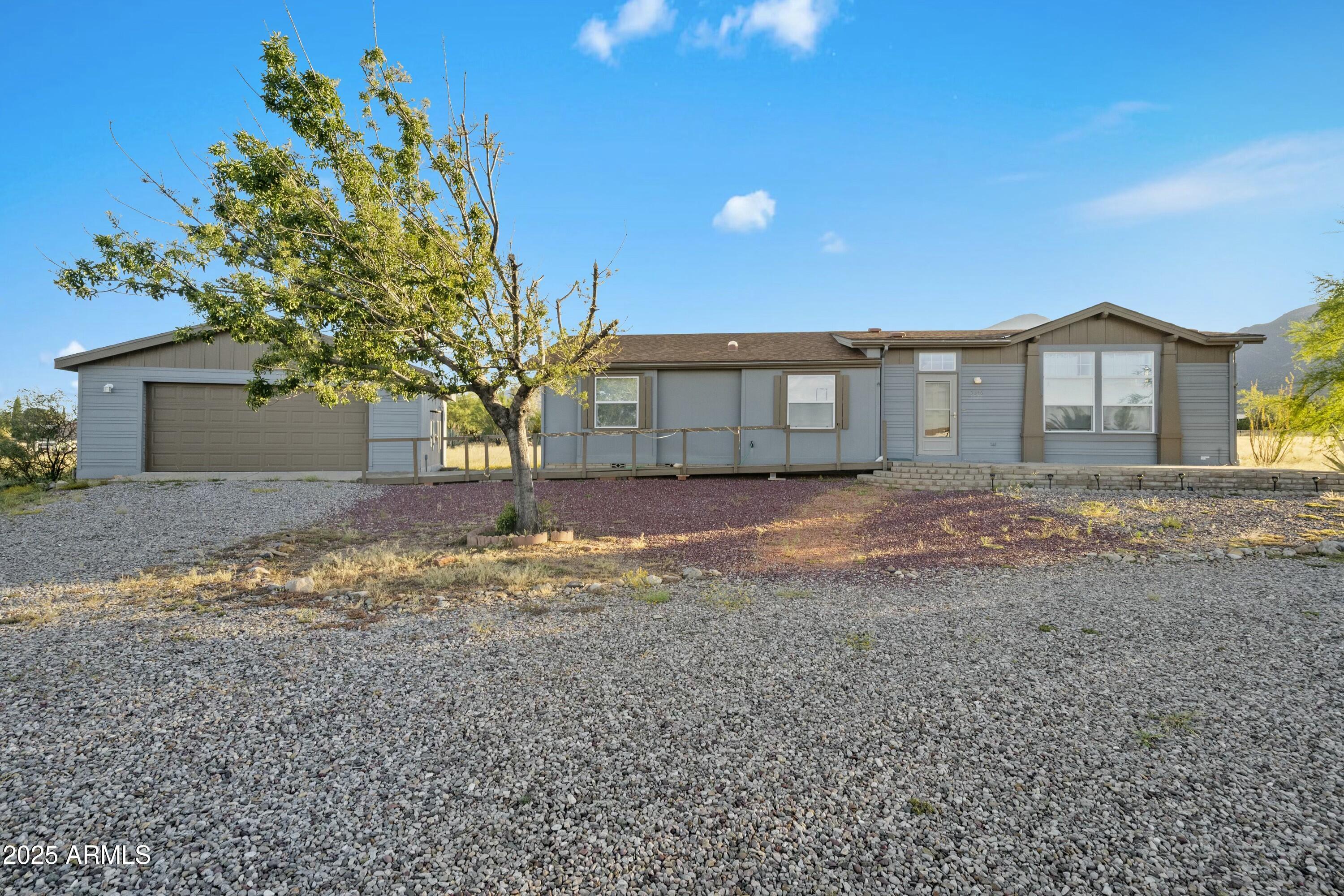 Discover breathtaking views of the Huachuca Mountains from this charming treasure situated on a generous 0.8+ acre corner lot! Outside, you'll find a wonderful detached garage and a ramp for easy access to your front door! Step inside and let the bright, airy living room envelop you in its warm ambiance, while the spacious dining room adjacent to the kitchen is ideal for entertaining guests! The laundry room offers plenty of storage, making it the perfect space to keep your cleaning supplies neatly organized. All bedrooms are generously sized, and the primary suite boasts a large walk-in closet along with a stunning ensuite bathroom featuring a separate tub and shower! Plus, there's additional storage available. But that's not all! Don't miss this incredible opportunity!