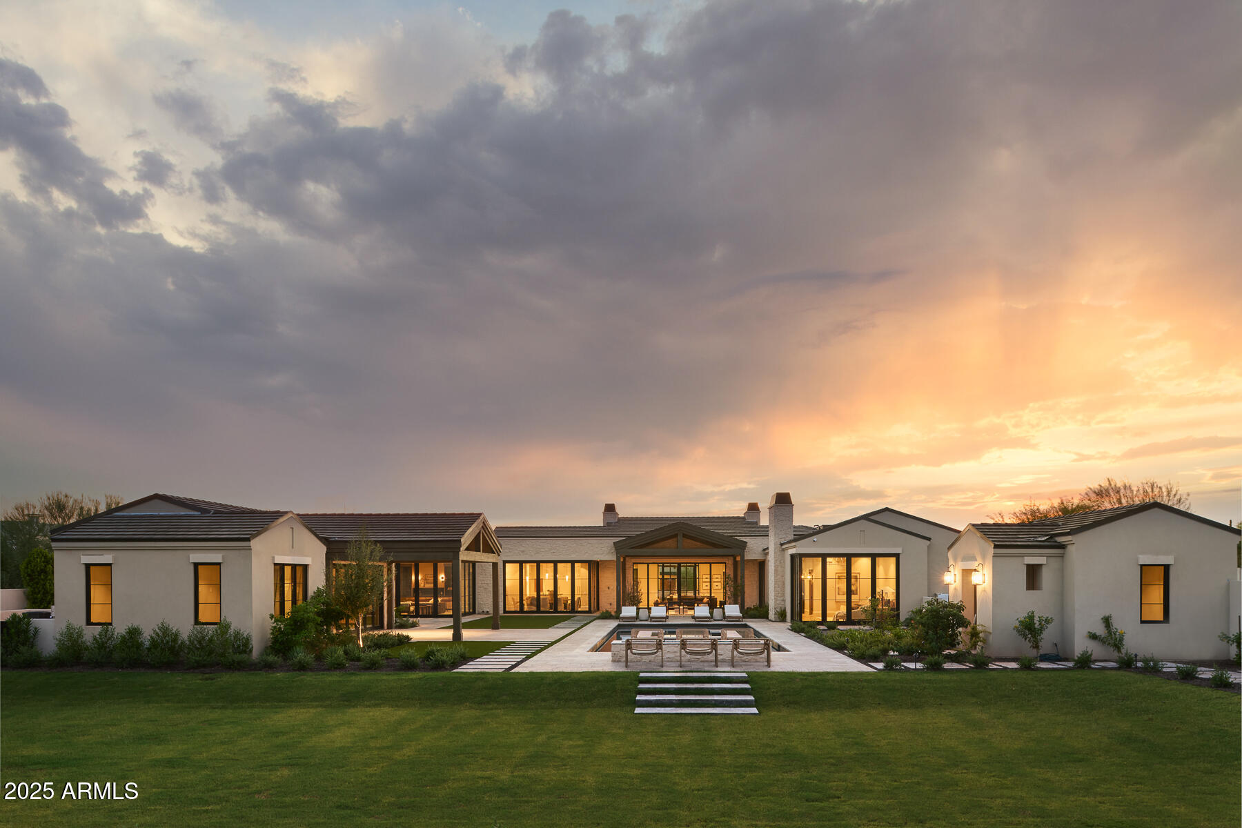Form and function exist harmoniously in this stunning property, featuring nearly 5000sqft of climate-controlled garage space. Six bays (lifts can be accommodated) plus an RV garage, workspace and a half-bath make this a stand-out. The main home offers an owner's wing with a gym, including a cold plunge and sauna, and an ensuite office, or bedroom 5. A fantastic kitchen with a custom skylight creates beautiful natural light throughout the heart of the home. A game room opens up to an outdoor kitchen. The detached guest house features a kitchen, living room, ensuite bedroom and a delightful outdoor patio. Ample indoor-outdoor entertaining spaces on this oversized lot, including a pickleball court and sports pavilion. Gorgeous views of Camelback Mountain and the Preserve serve as a backdrop.