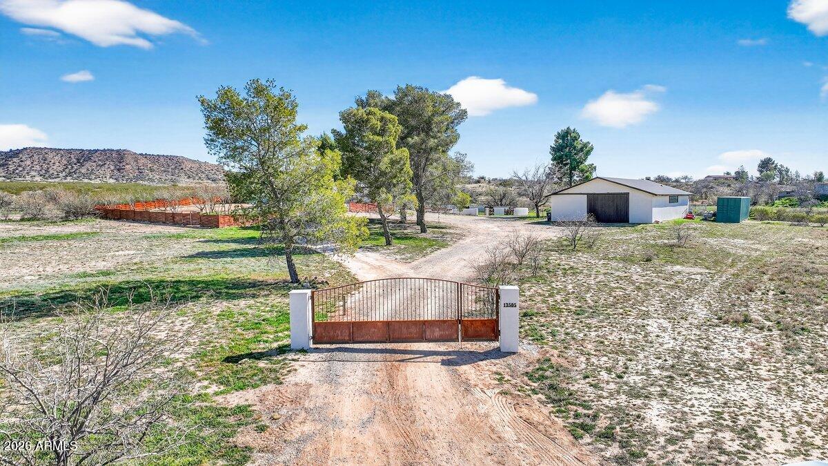 A great private rural location situated on 5.17 acres bordering Prescott National Forest...
3768 sf that will accommodate single family, multi-generational or could  be two complete residences...one up...one down...Beamed ceilings throughout...Upstairs is two bedroom, two bath...Living room with wood burning fireplace that opens onto expansive deck overlooking National Forest to House Mtn....Kitchen/Dining room with concrete counter tops, SS appliances...HUGE primary suite with  access to deck, features  full bath and large walk-in closet....Sub-level has living room with woodburner, two bedrooms, one full bath, two bonus rooms, and a full kitchen...downstairs accesses exterior block walled courtyard...2,376 square foot shop building with 240 watt/ 20 amp service...Fantastic property!